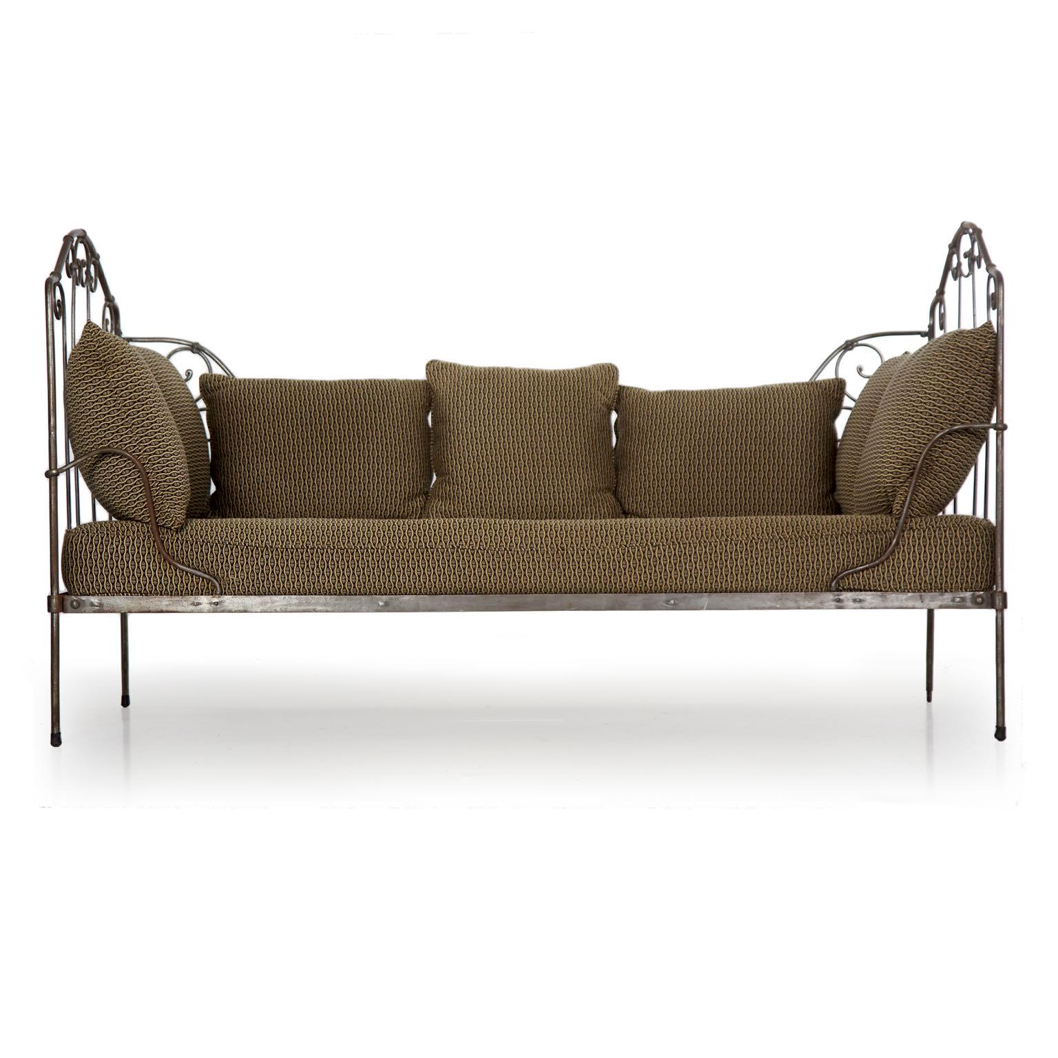 We love this gorgeous wrought iron bed with its rustic craftsmanship and worn pitted surfaces. The mild steel frame is only minimally finished with square pounded wrought tenons locking various elements through the sides. The entire body folds down