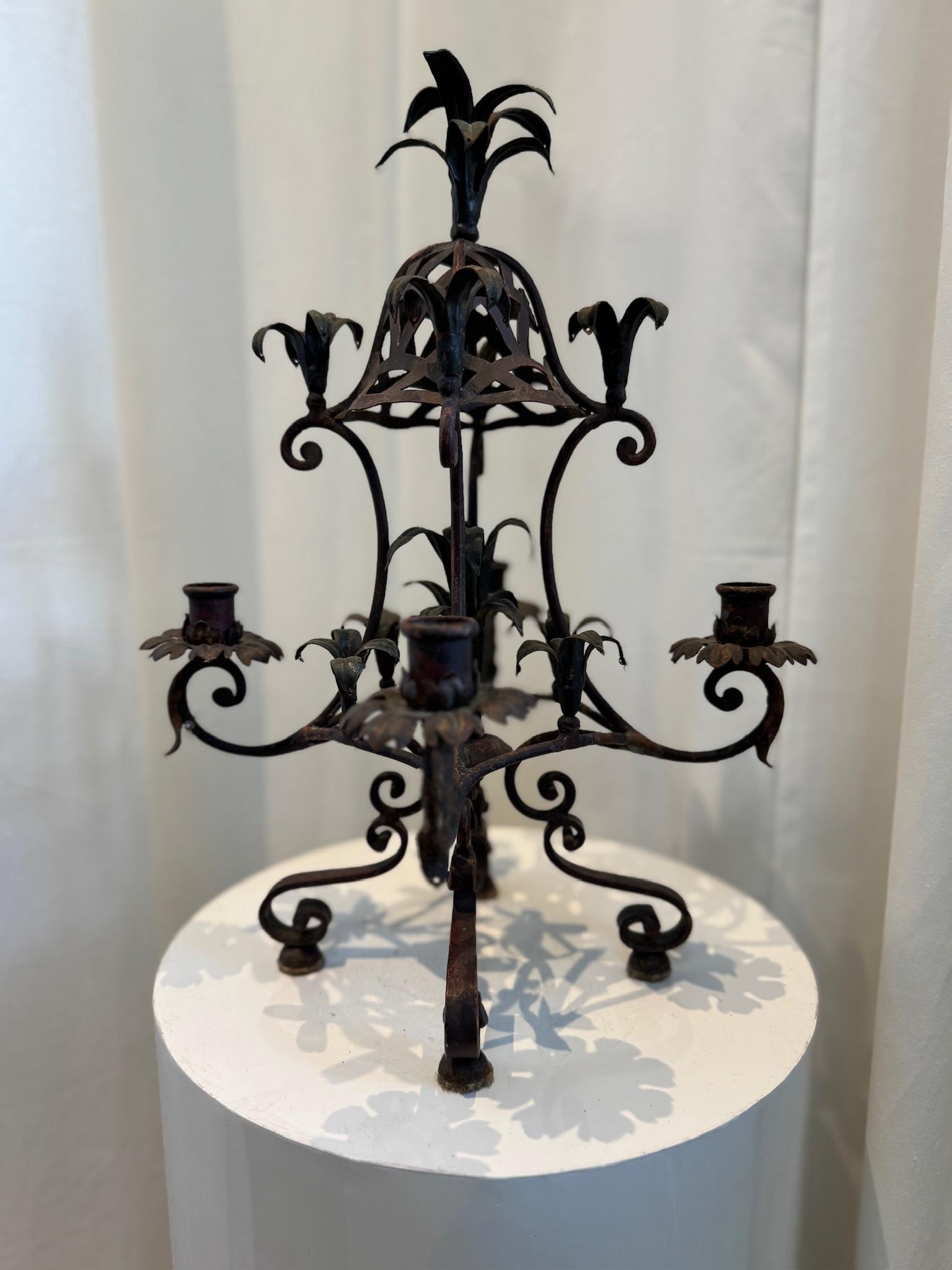 This striking antique wrought iron candelabra beautifully captures the elegance and meticulous craftsmanship of early 20th-century French design. Hand-forged with extraordinary attention to detail, it showcases a harmonious blend of Gothic and