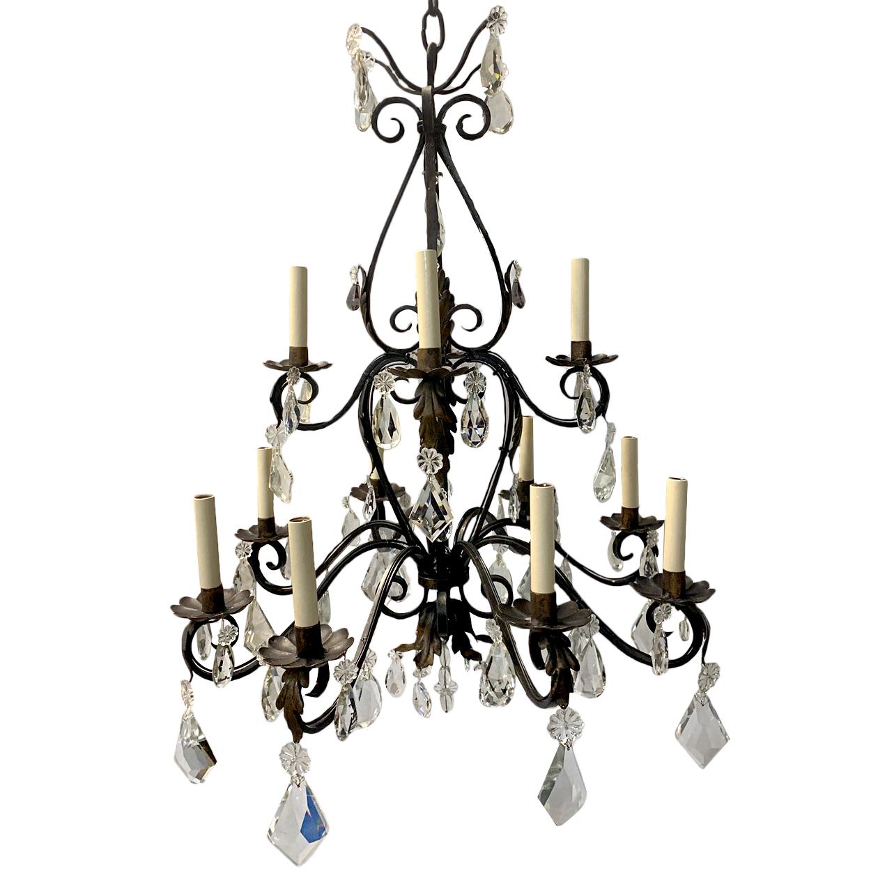 A French circa 1900s wrought iron double tiered twelve-light chandelier with crystals and original patina. 

Measurements:
Height 35