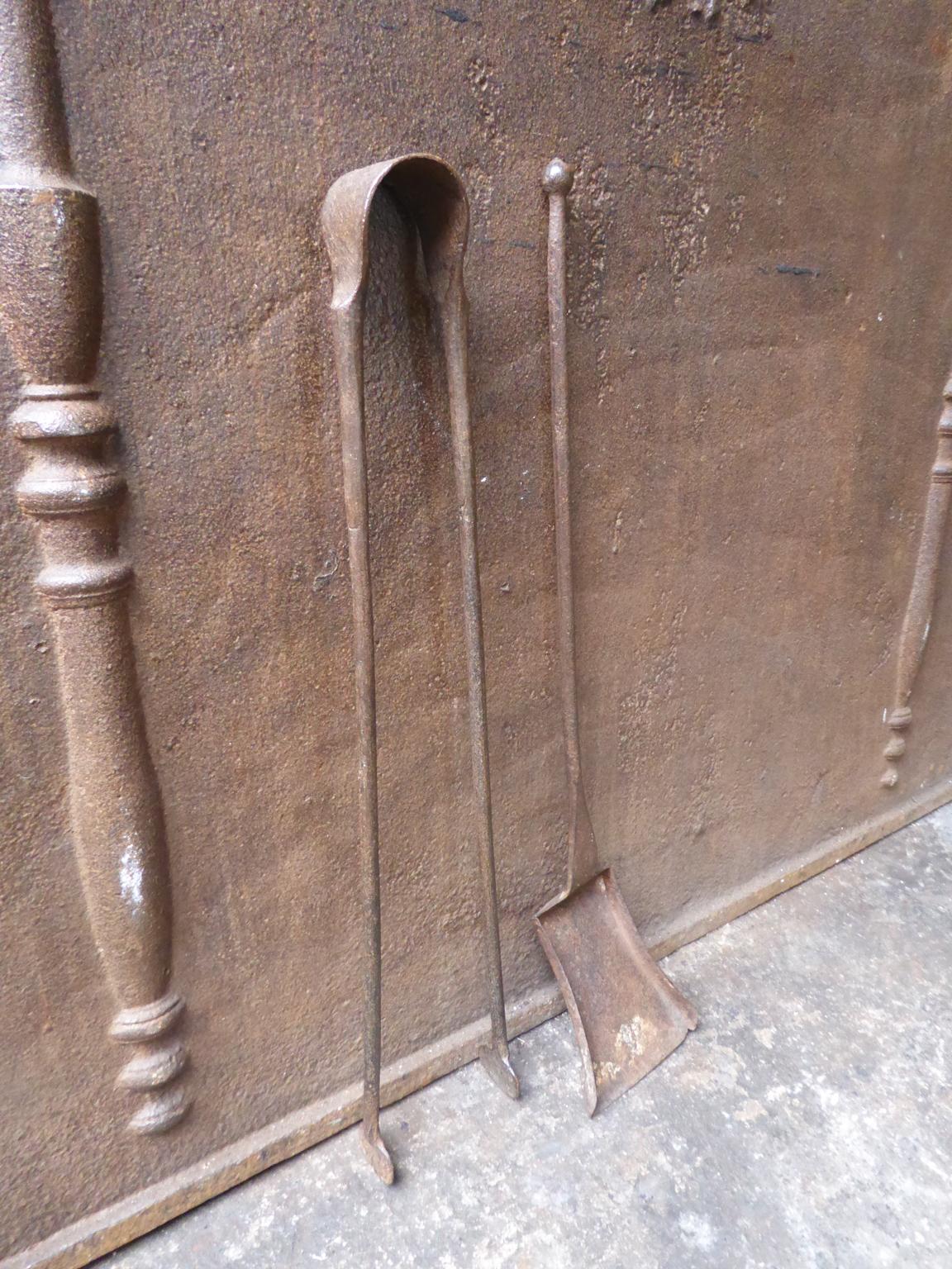 18th century French Louis XV fireplace tool set consisting of fireplace tongs and a shovel. The fire irons are made of wrought iron. They are in a good condition and are fully functional.