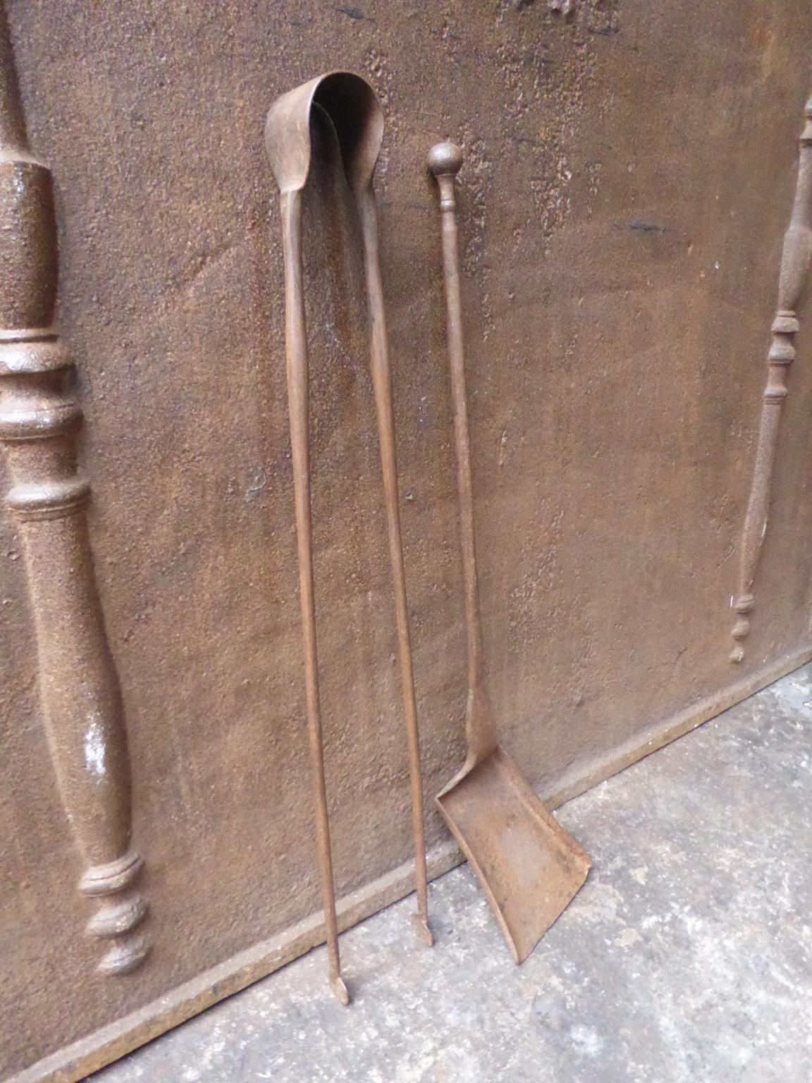 18th century French Louis XV fireplace tool set consisting of fireplace tongs and a shovel. The fire irons are made of wrought iron. They are in a good condition and are fully functional.