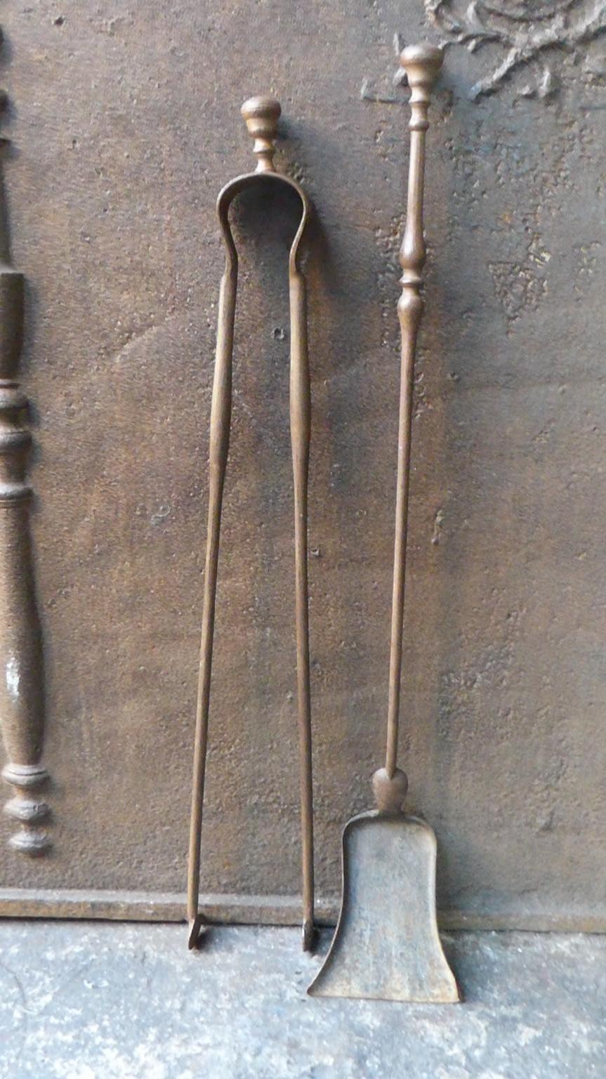 19th century French Napoleon III fireplace tool set consisting of fireplace tongs and a shovel. The fire irons are made of wrought iron. They are in a good condition and are fully functional.