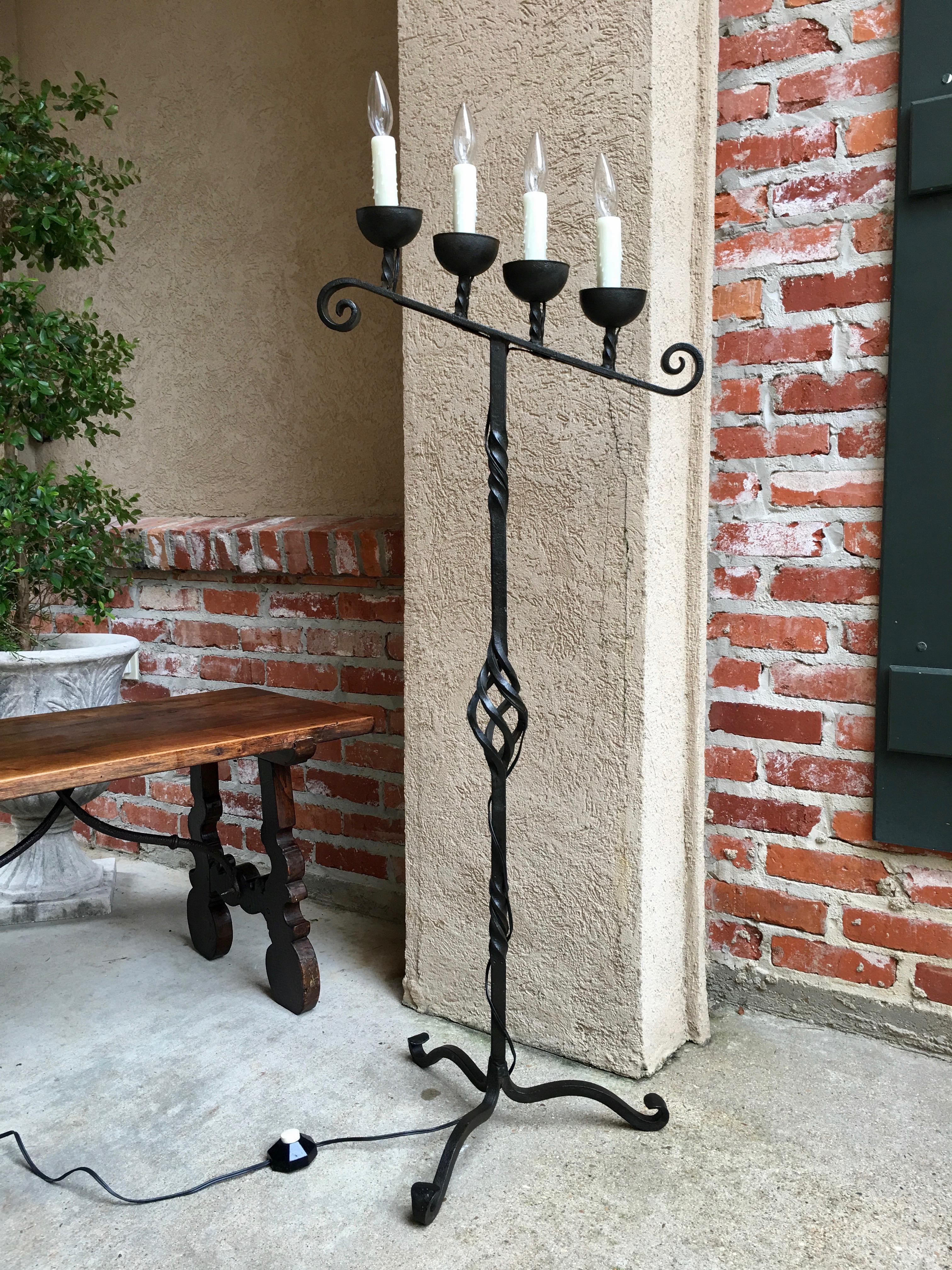 ~Direct from France~
~A gorgeous 4-light antique wrought iron floor lamp with slanted height candle holders, like an antique candelabra fresh out of a French country home or chapel!~
~Four deep metal cups each hold a faux wax candlestick over the