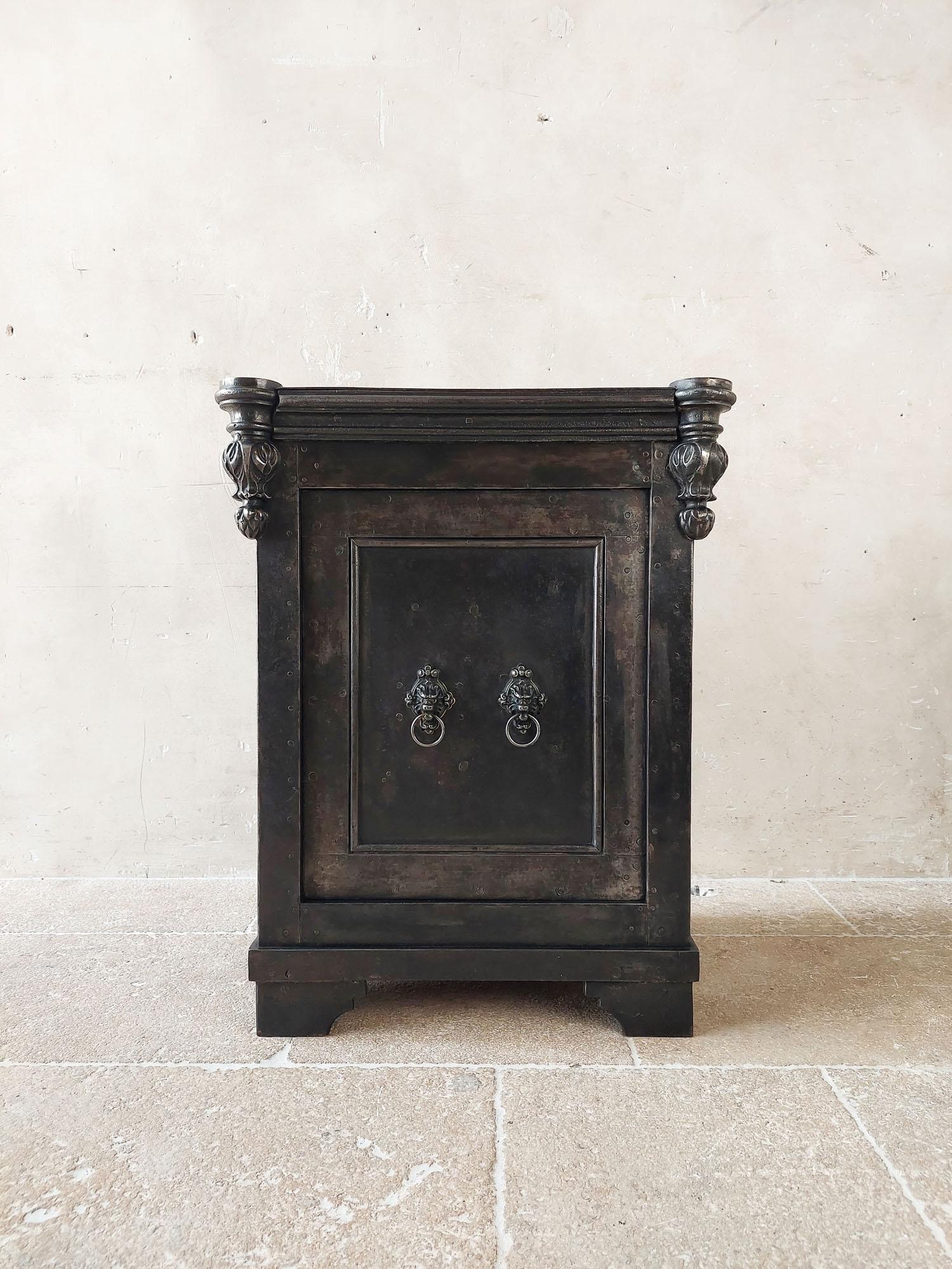 Antique French wrought iron safe, circa 1870. Partly riveted and quite unique due to its beautiful cast iron ornaments on the corners and the lion’s heads. This locker also has a safe function with insulated wall and 2 doors.

h 78.5 x w 61.5 x d