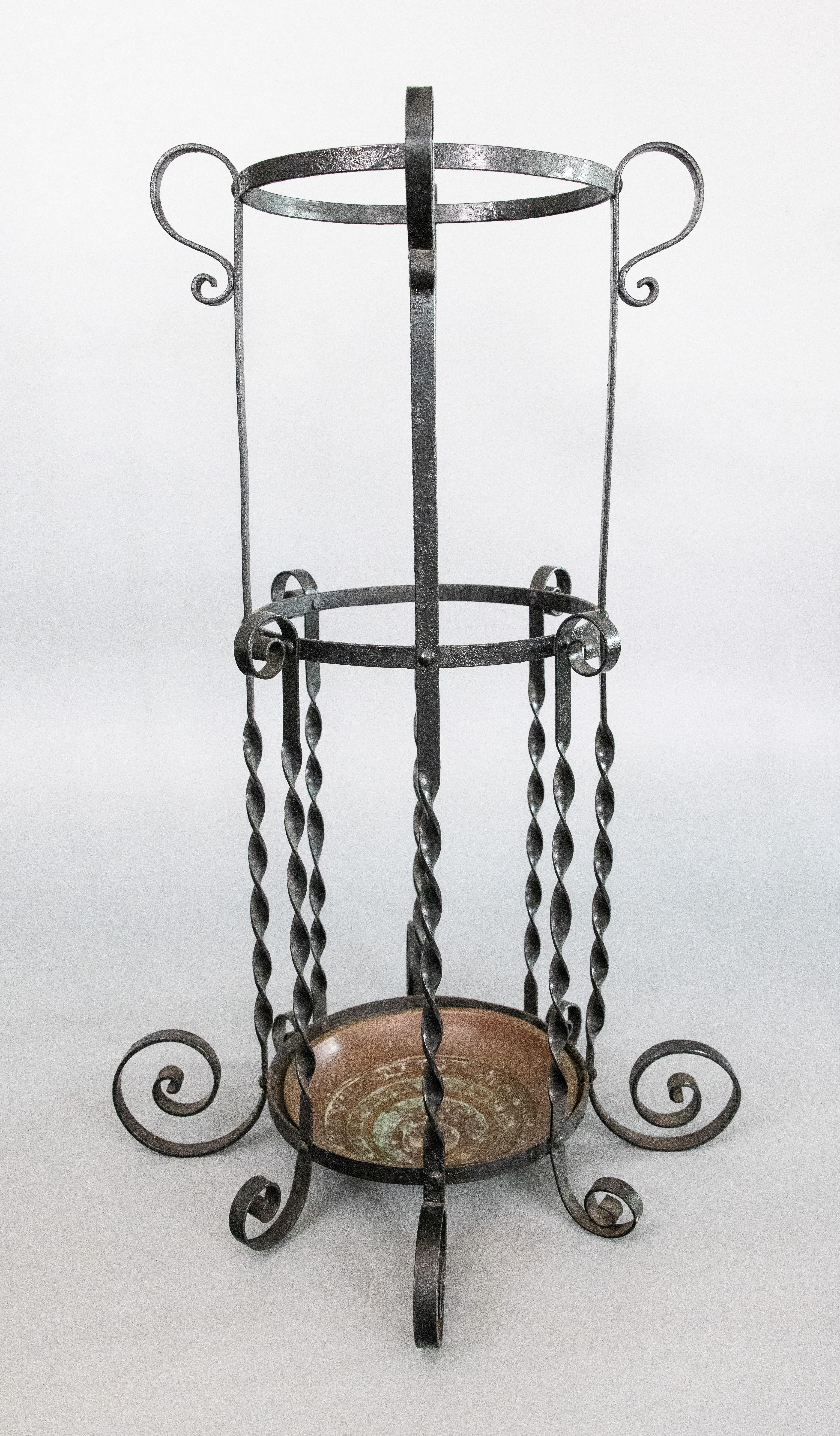 A lovely early 20th-Century French wrought iron umbrella or stick stand with the original copper liner. It's a fine quality hand crafted piece that would be stunning in an entryway for umbrellas or walking sticks.

DIMENSIONS
16.5ʺW × 16.5ʺD ×