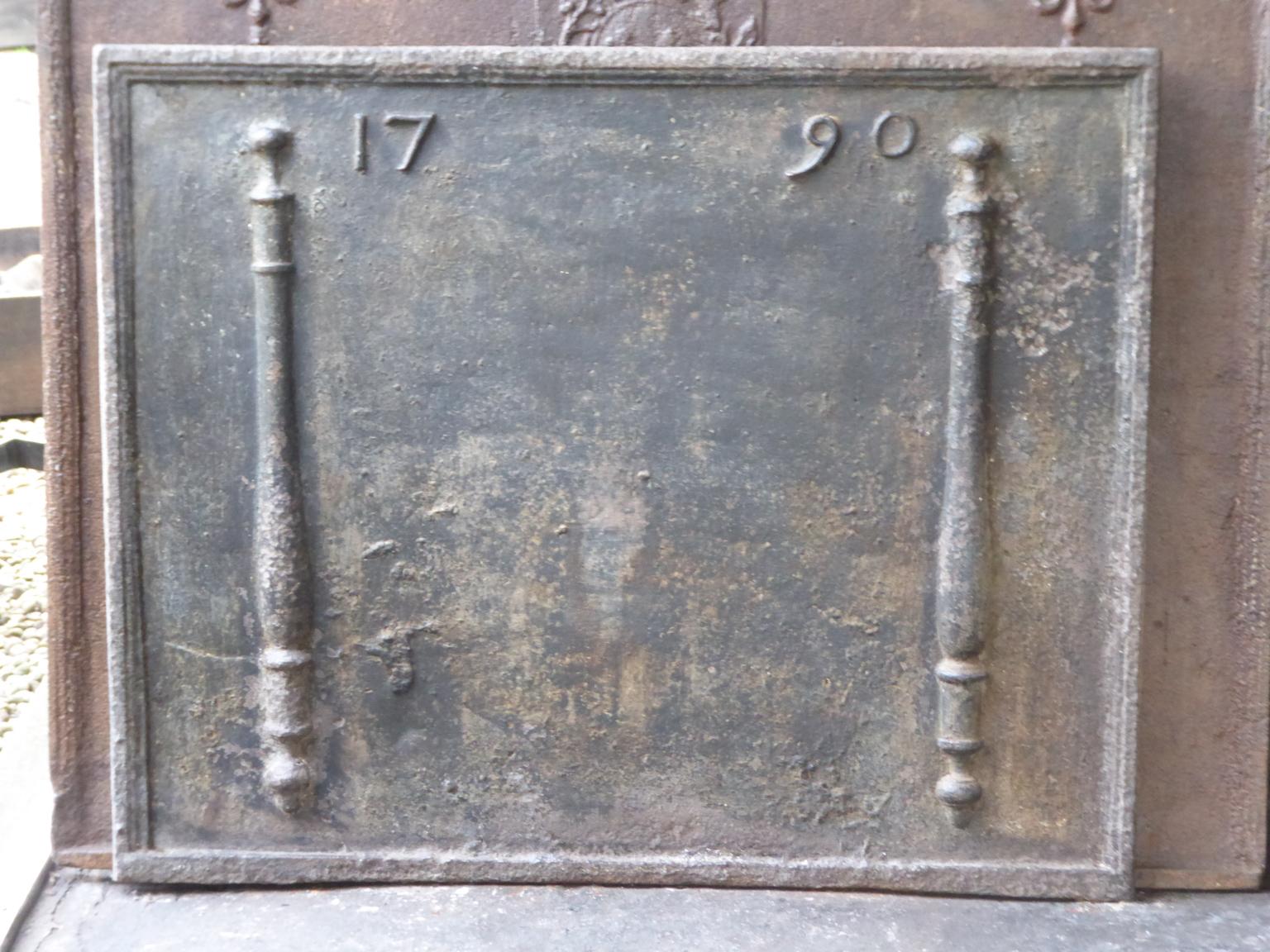 18th century French Louis XV fireback. The date of production, 1790, is cast in the fireback. The pillars refer to the club of Hercules and symbolize strength and the unknown.

The fireback is made of cast iron and has a natural brown patina. Upon