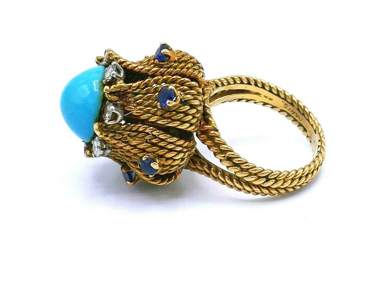 Spectacular antique ring made of 18k (tested) braided yellow gold featuring turquoise, sapphire and diamond. Total carat weight of the diamonds is 0.28 pts. 
Stamped with a serial number and a place of origin (Paris). 
Measurements: the ring size is