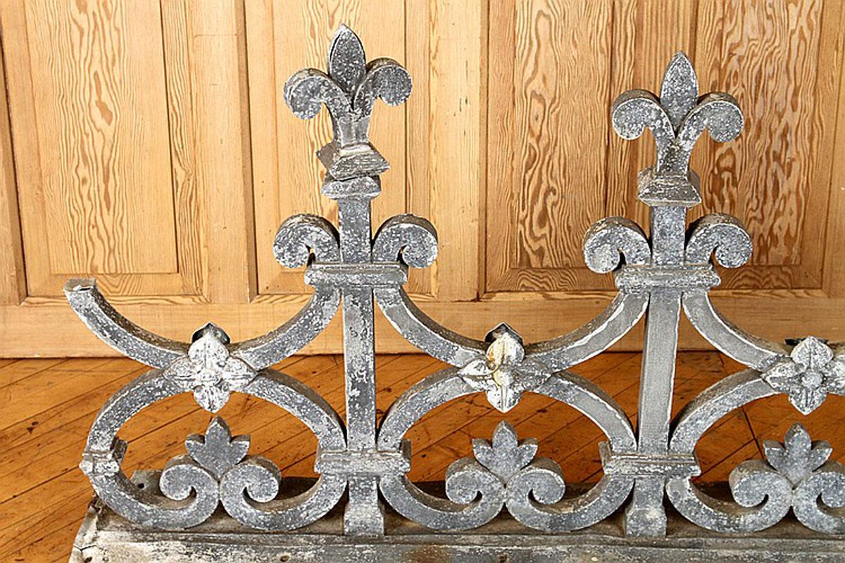 Neoclassical style building element in the neoclassical taste. Having scrolling design with fleur de lis finials. This item comes with two detached pineapple form finials. Great to use for garden decoration or mount on wall as sculptural decoration
