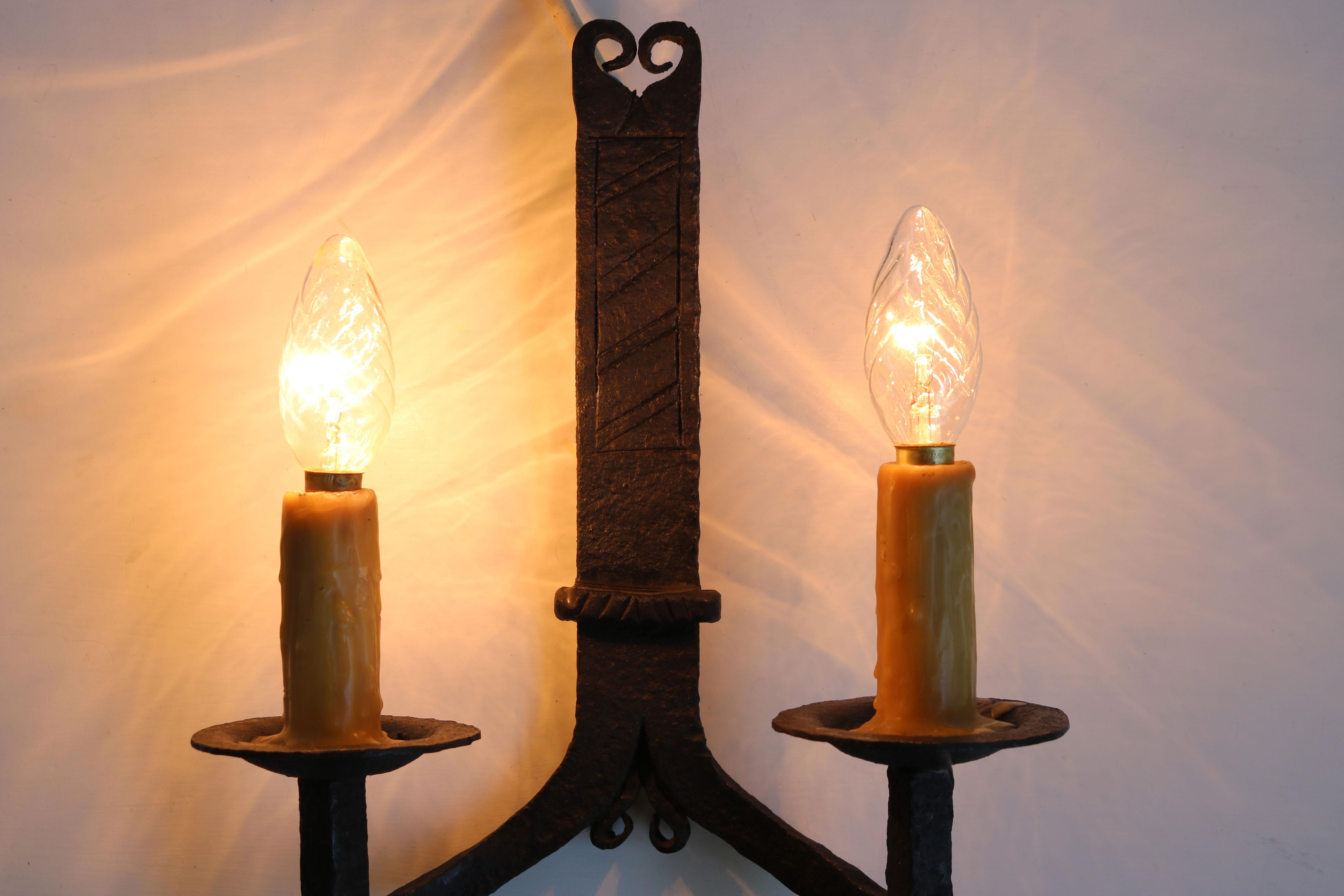 Lovely pair of hand-crafted wrought iron wall lights from France 1900. Gothic revival style or Arts & crafts. 
They are heavy and fully hand made, really gorgeous details. 
Fully original with gorgeous candle wax covered light sockets. 

They