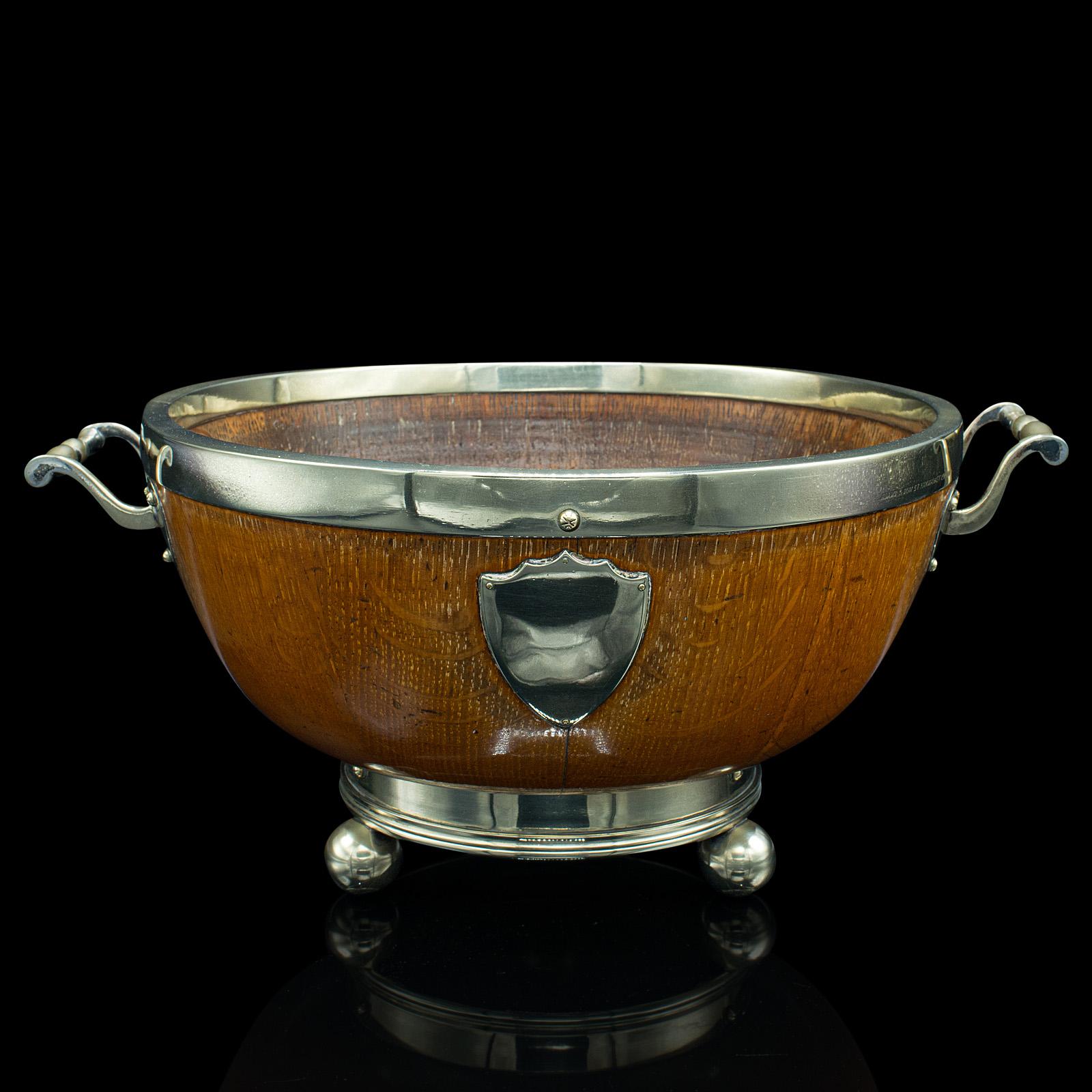This is an antique fruit bowl. An English, oak and silver plate country house serving dish, dating to the Victorian period, circa 1870.

Strikingly attractive appearance with the contrast between the materials
Displays a desirable aged patina and
