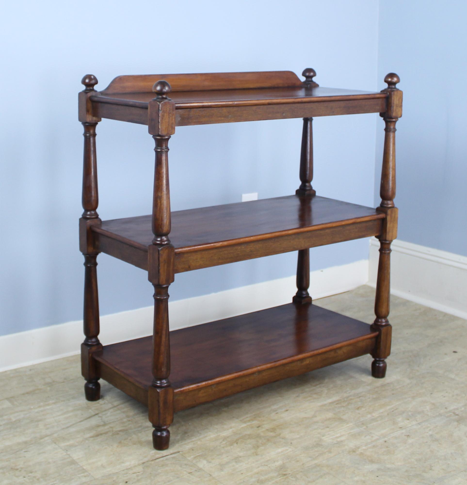 An antique dumbwaiter, shelf, or serving piece in rich dark fruitwood. In very good condition with nice patina. Approximately 11.5 inches in height between the shelves. There are so many possible uses for this piece that we cannot list them!