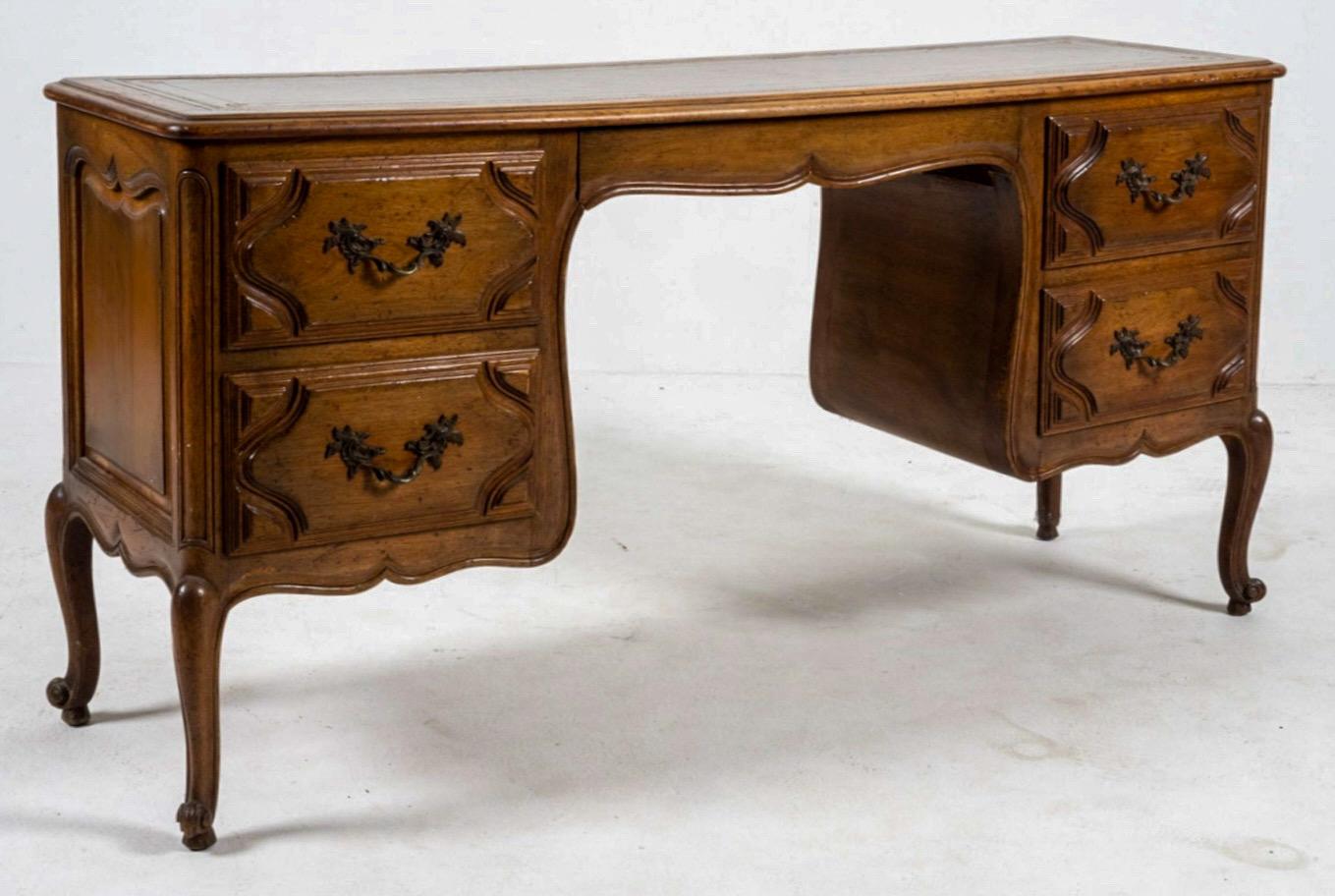 One of my favorite things about this piece is its size. It is a late 19th century French carved fruitwood desk. It could also work well as a vanity or console table. The drawers have dovetail construction. The top is a tooled brown leather. It could