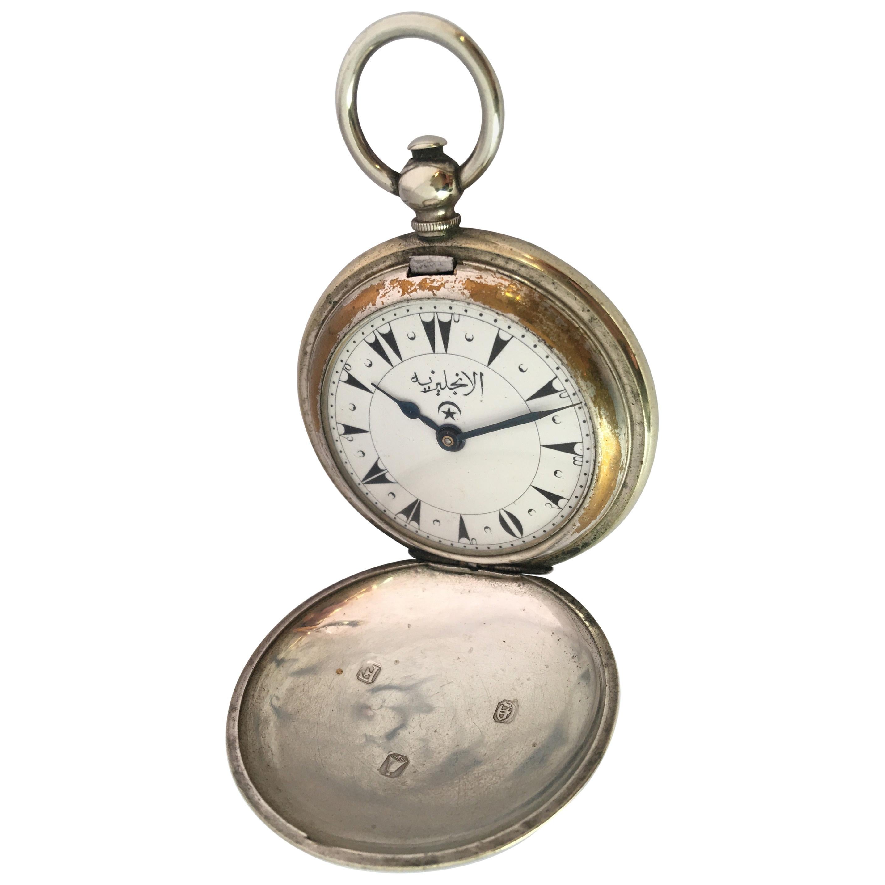 Nickel cased hunter pocket watch for the Turkish market, unsigned movement, the dial with Turkish numerals and blued steel hands, engine turned case, 54mm. 

This watch is in good working condition and it is ticking well. Visible signs of ageing and