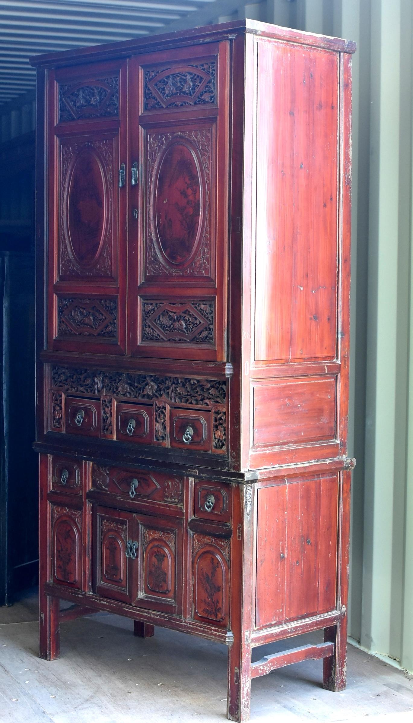This rare, magnificent, fully carved cabinet was a scholar's treasure chest. Hand-painted oval door panels depict the leisure lives of fisherman and a strolling scholar. Fully carved facades showcase scenes from an opera of a victorious historic