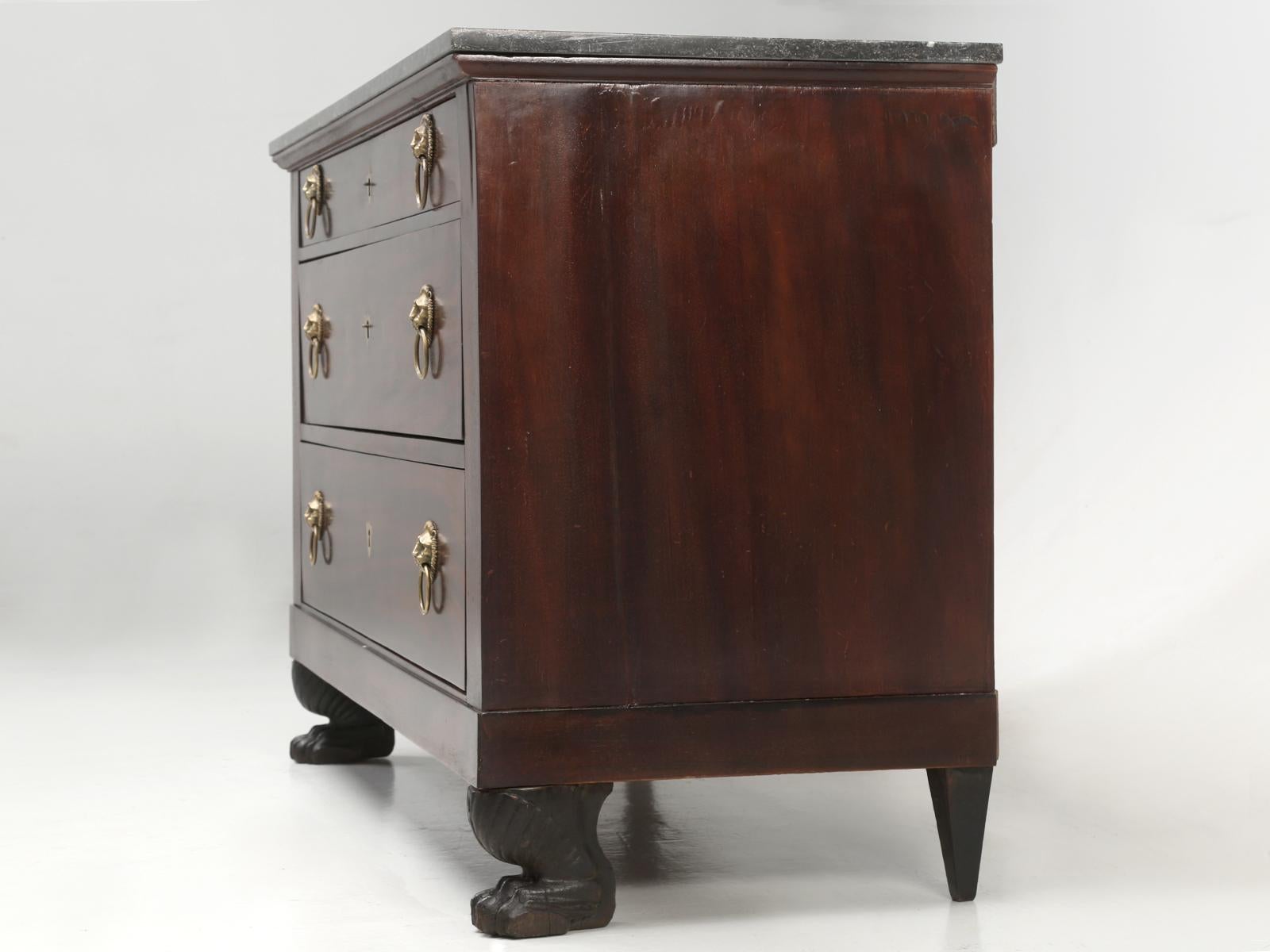 Restored antique French Empire (1804-1815), or Restoration (1815-1830) commode. Made from mahogany veneer resting on lion claw feet. Each of the antique French commode drawers, were carefully reconstructed, so they now function as originally