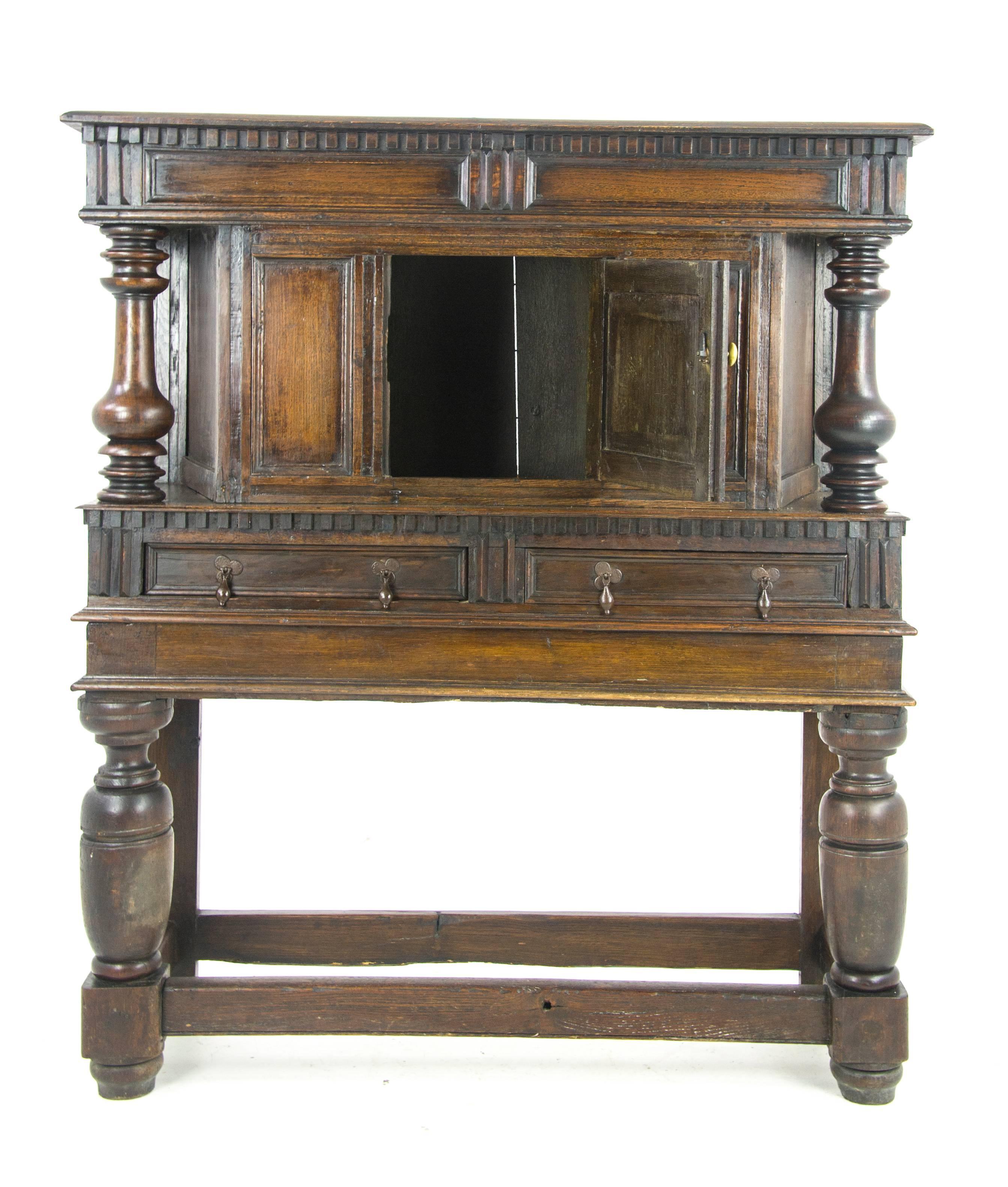 Antique furniture sideboard, Georgian court cupboard, Scotland, 1810

Scotland 1810
Solid oak construction
Original finish
Carved dentil cornice
Turned pillars on sides
Small carved panel door with interior storage
Dentil frieze
Pair of dovetailed