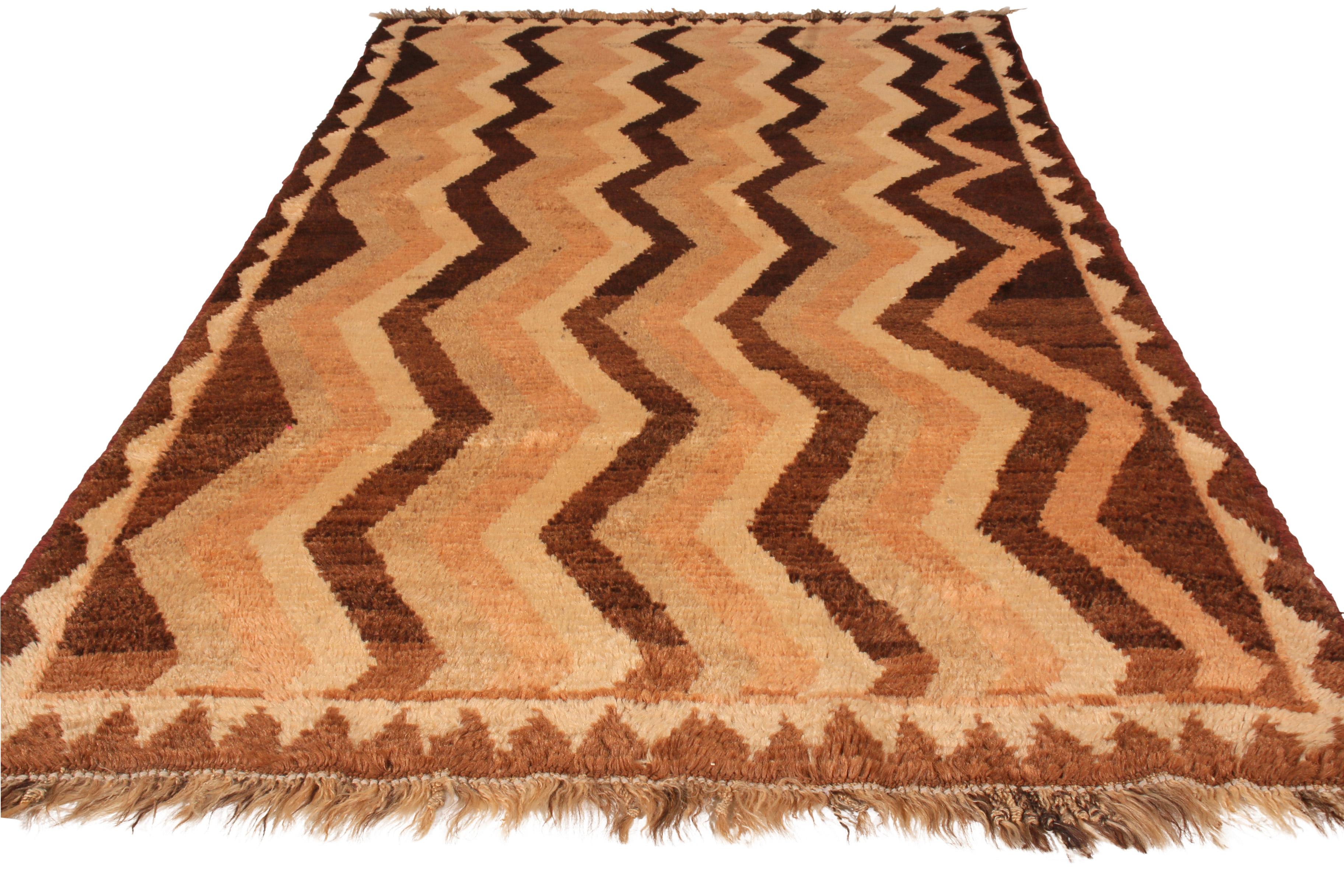 Made with hand knotted wool and originating between 1910-1920, this antique Gabbeh Persian rug recaptures the Classic chevron pattern its lineage is known for in an uncommonly reserved colorway pallet, enjoying warm and rich juxtaposition of beige