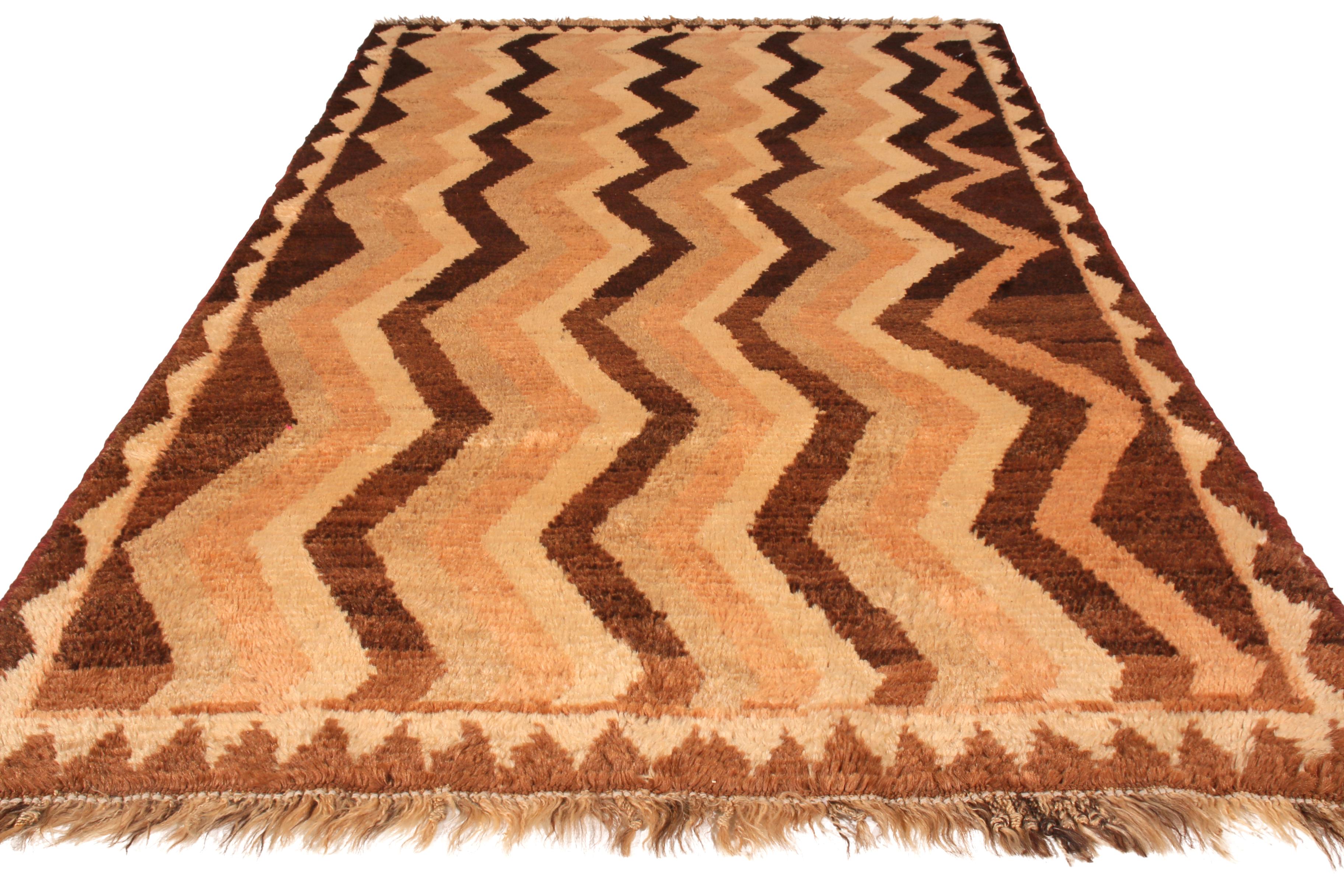 Made with hand knotted wool and originating between 1910-1920, this antique Gabbeh Persian rug recaptures the Classic chevron pattern its lineage is known for in an uncommonly reserved colorway pallet, enjoying warm and rich juxtaposition of beige