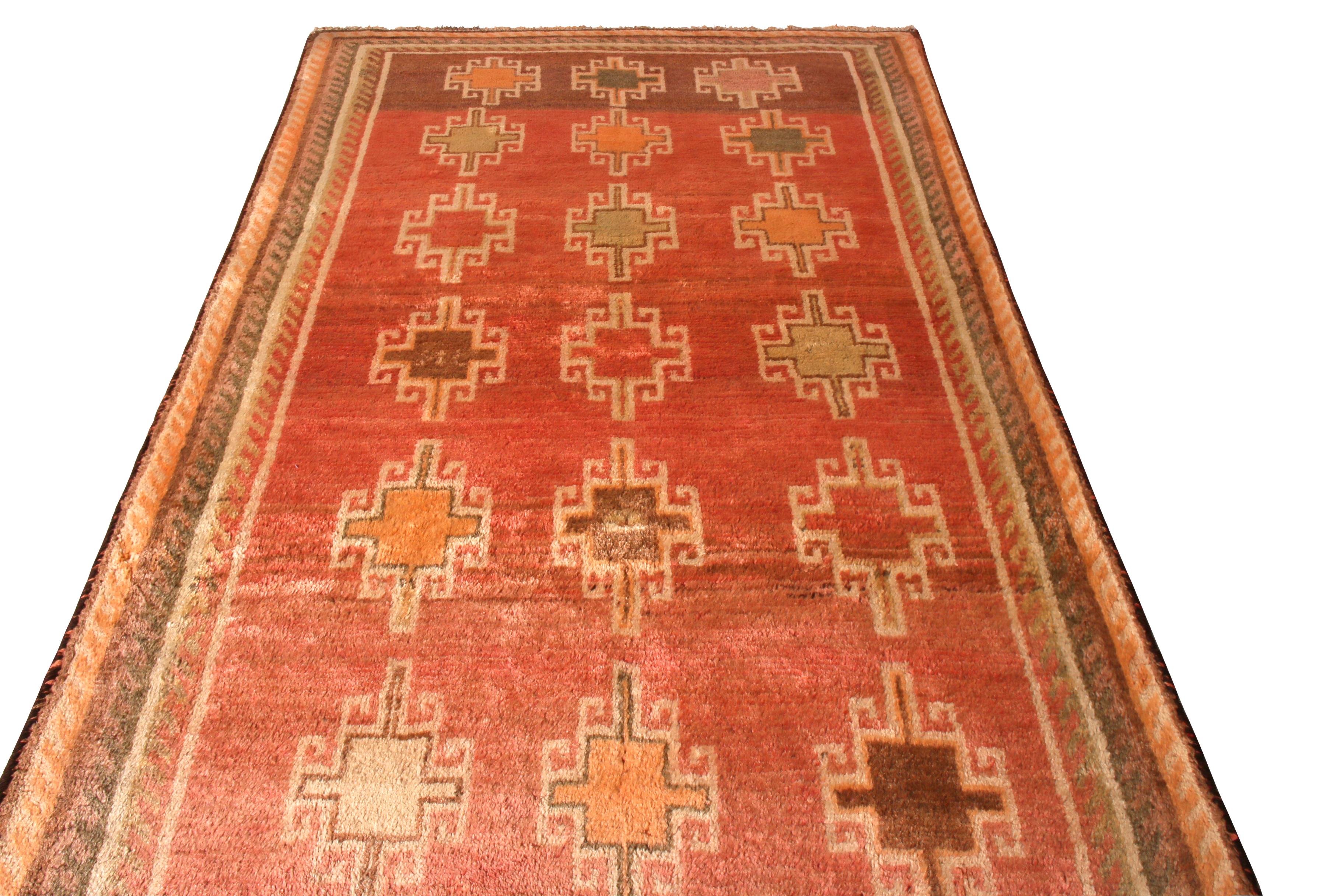 Hand knotted in wool originating from Persia, circa 1910-1920, this antique Persian rug enjoys a unique coral red-orange colorway seldom seen in this extent, complementing a particularly lustrous, lush pile height it boasts as a gabbeh tribal rug.