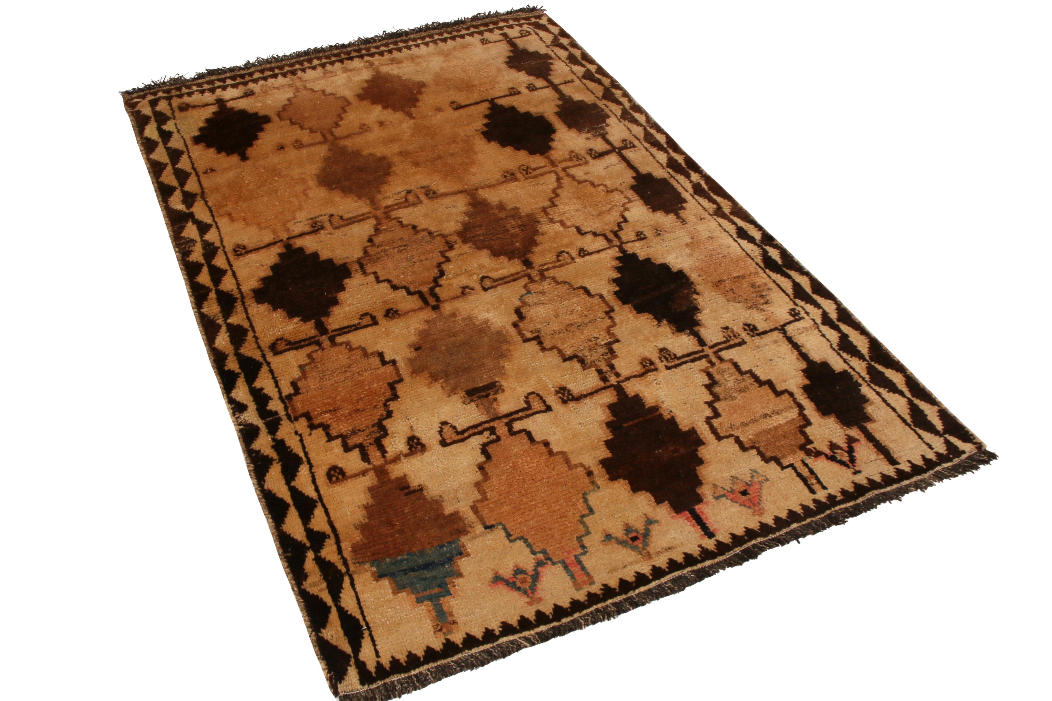 Hand knotted in wool originating from the Gabbeh tribal weavers circa 1950-1960, this mid-century Persian rug enjoys a visually bold vintage diamond pattern with tasteful variations in definition complementing the array of beige-brown and black hues