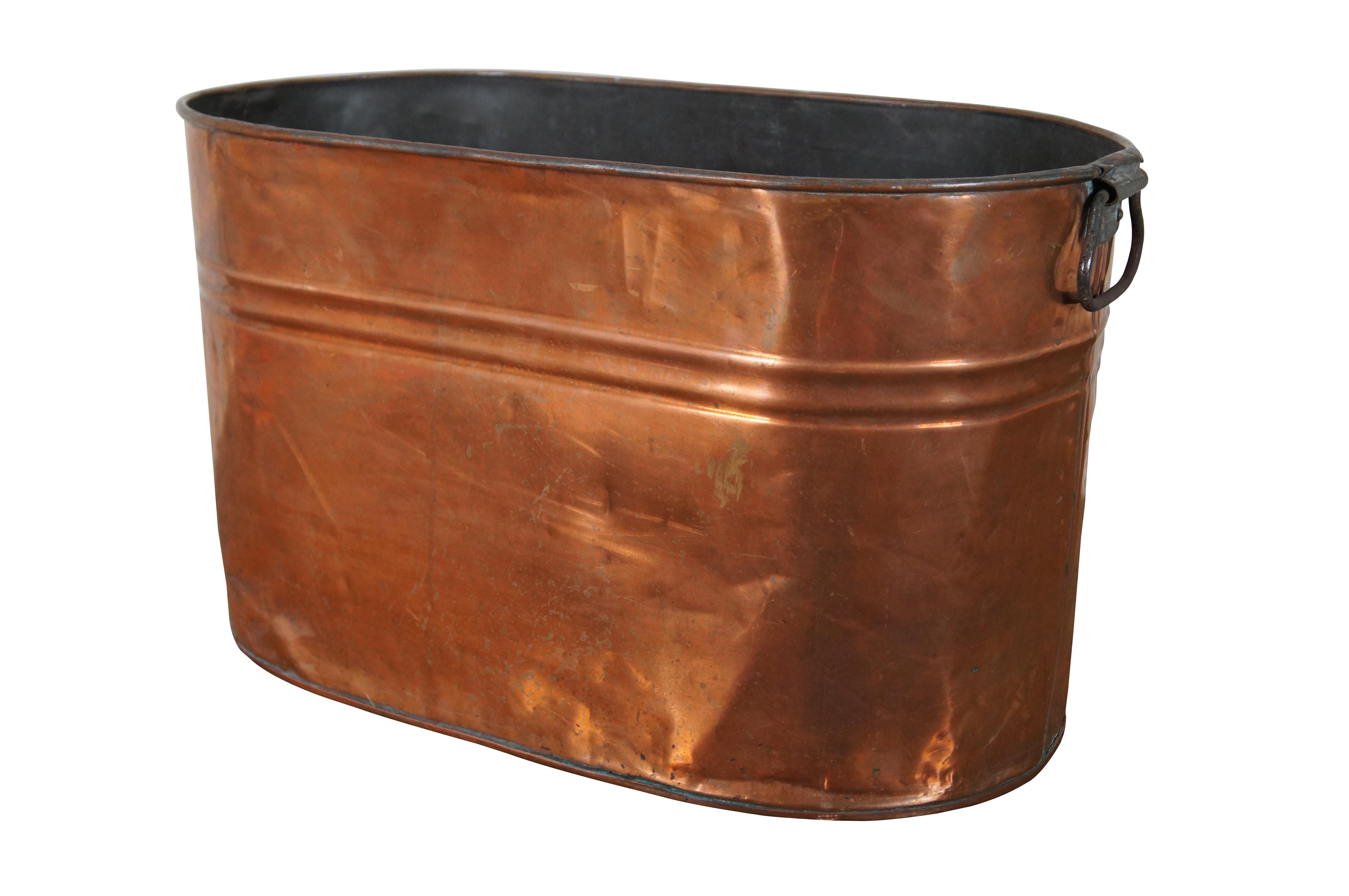 Antique early 20th century copper boiler / wash tub, oval shaped with iron handles. Measure: 22