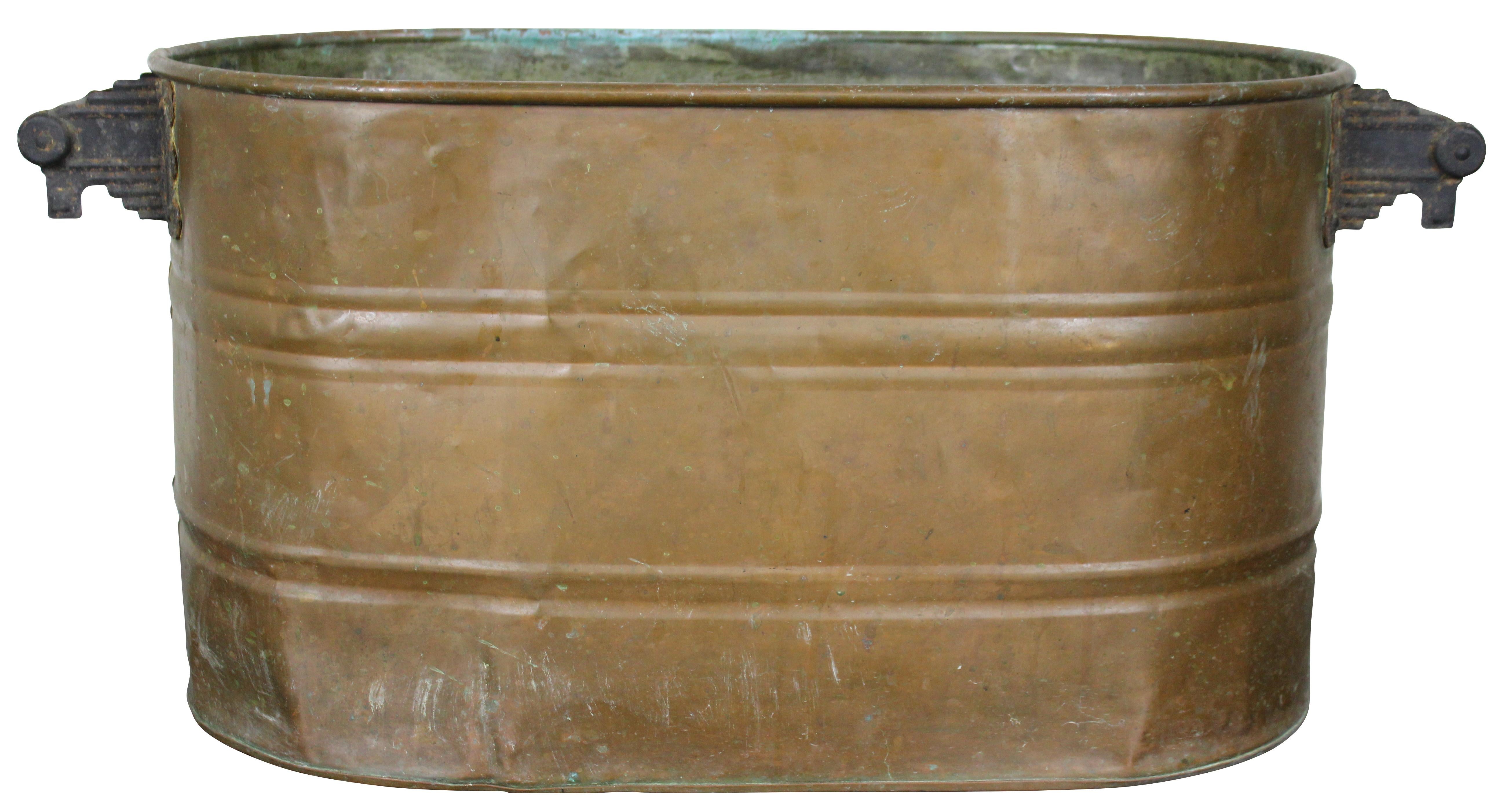 Antique copper boiler, firewood bin or wash tub with Art Deco style iron handles. Measure: 28”.

 