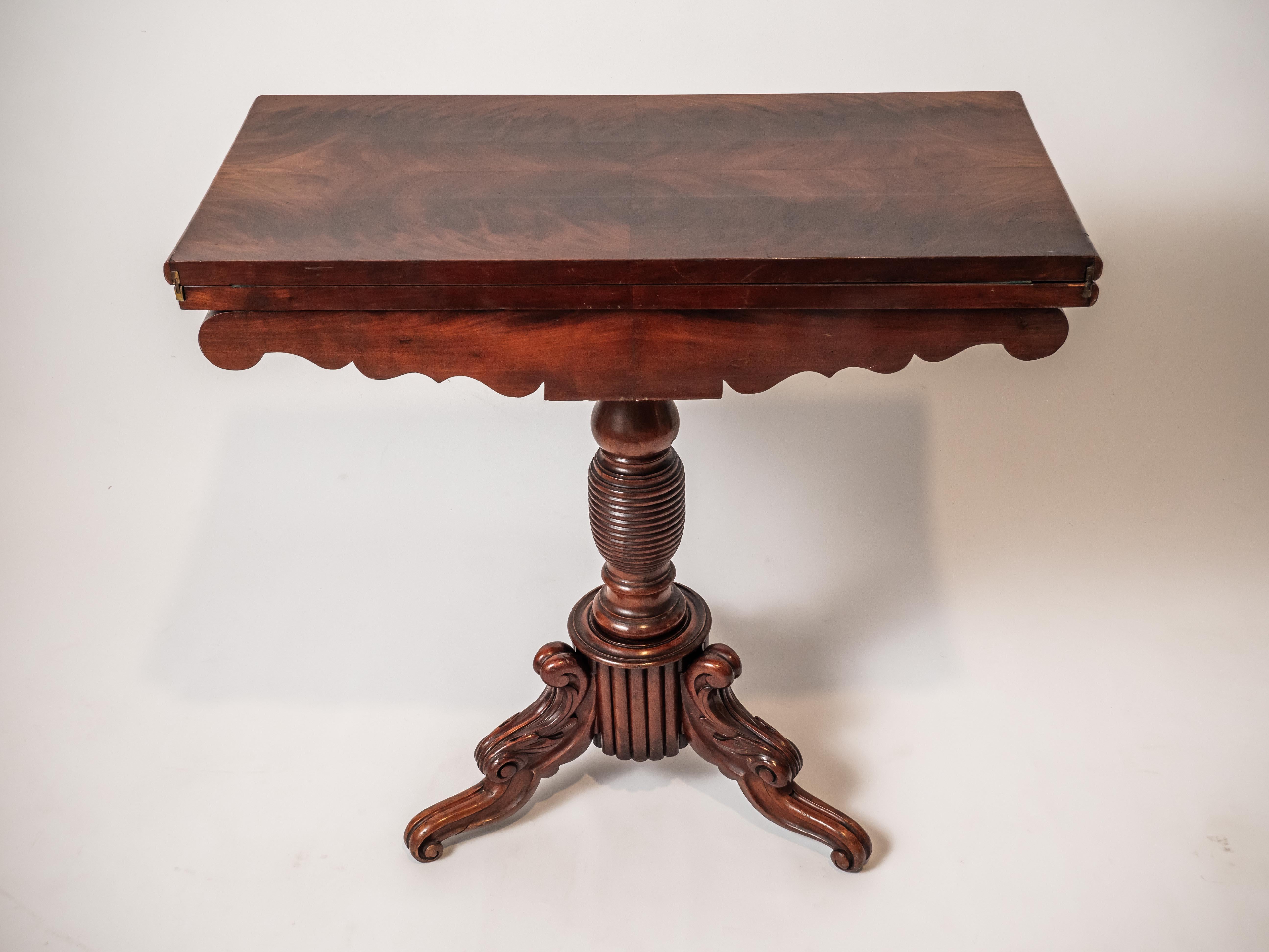 A 19th century hand-carved gaming table on a central leg divided by a tripod. Delicate floral carving. Inside the table there is storage space for cards / playing equipment. Material: Mahogany. Date: around 1860. Provenance: France. Condition: very