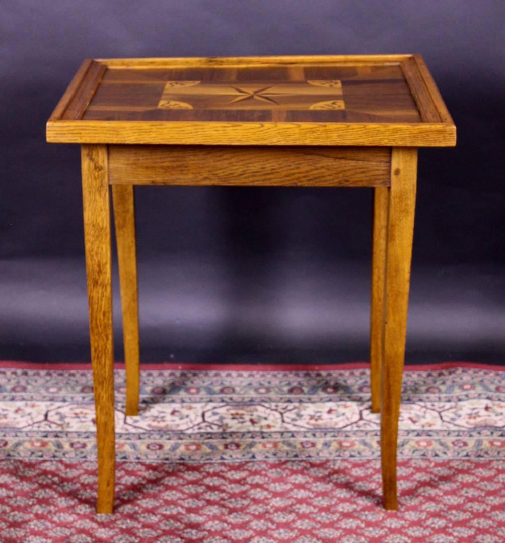 Wonderful game table or side table from the Biedermeier period. This amazing petite piece of furniture from the Pfalz region convinces with its beautiful star shaped marquetry on the tabletop. Made with great build quality out of walnut wood