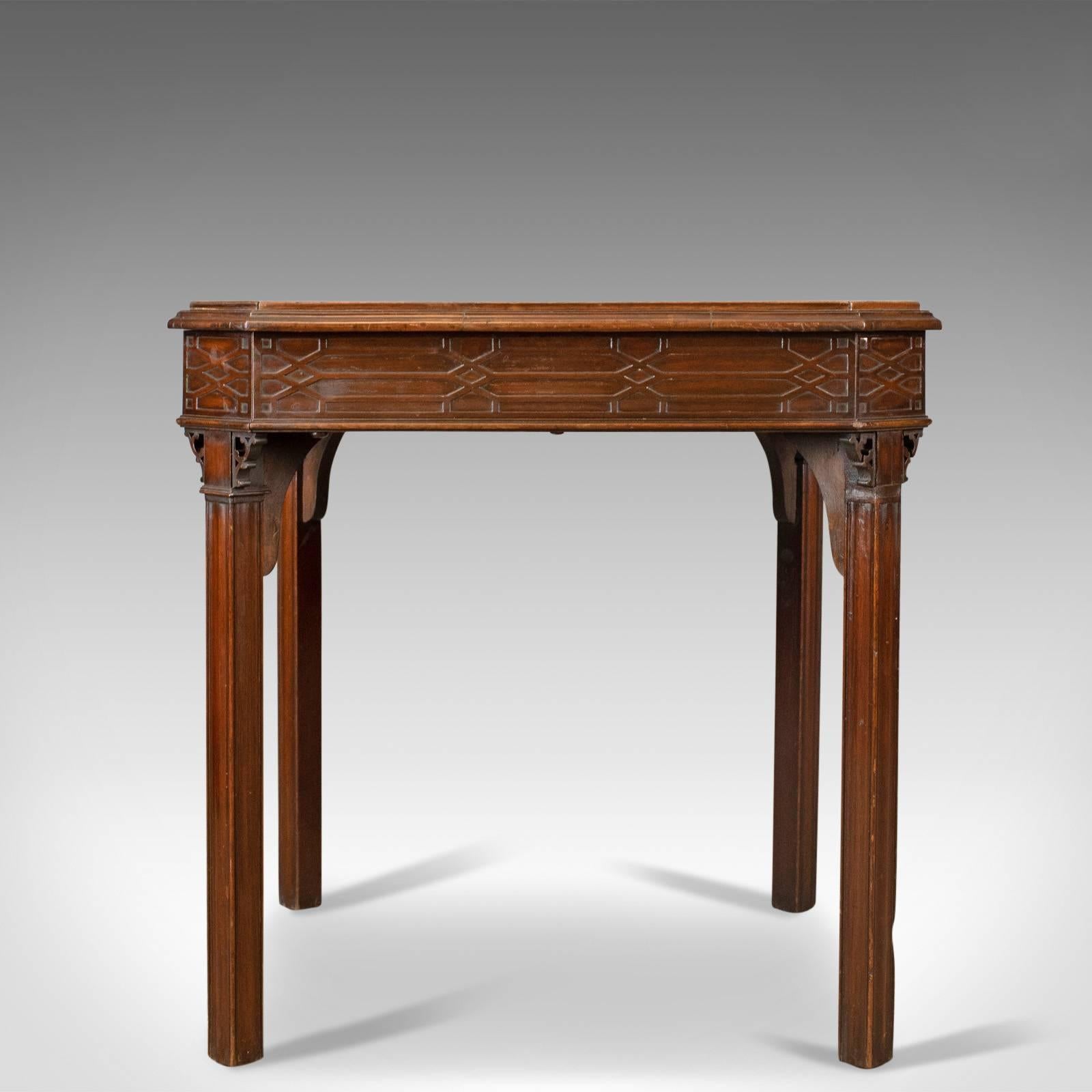 This is an antique games table, an English, Georgian, mahogany card table with oriental overtones dating to circa 1800.

Delightful square table with canted corners
Displaying oriental influence in the blind fret, frieze decoration
Raised on