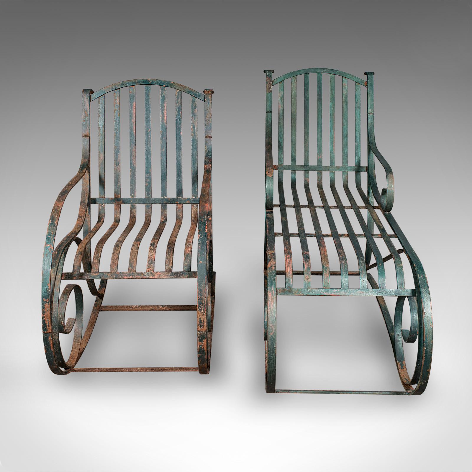 This is an antique garden lounger set. An English, wrought iron rocker and steamer chair, dating to the Edwardian period, circa 1910.

Striking country house retreat furniture, adding elegance to the veranda or poolside
Displaying a desirable aged