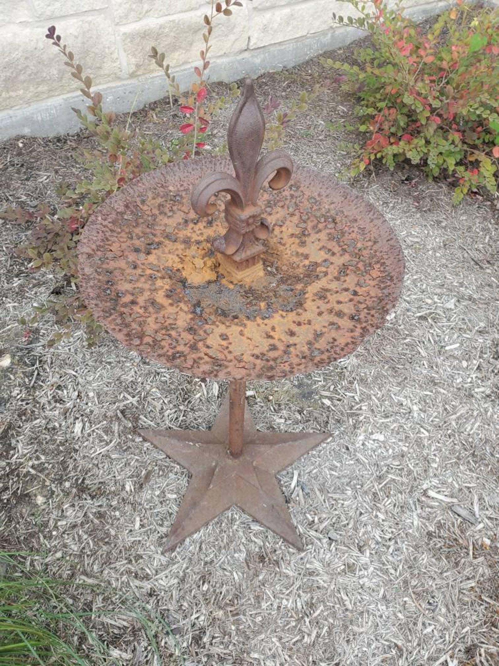 A one-of-a-kind antique architectural ironwork, handmade from salvaged building elements, having a rustic, heavily patinated circular disc/dish, with outstanding deep rust and burnt orange coloring and molten texture, surmounted by a regal