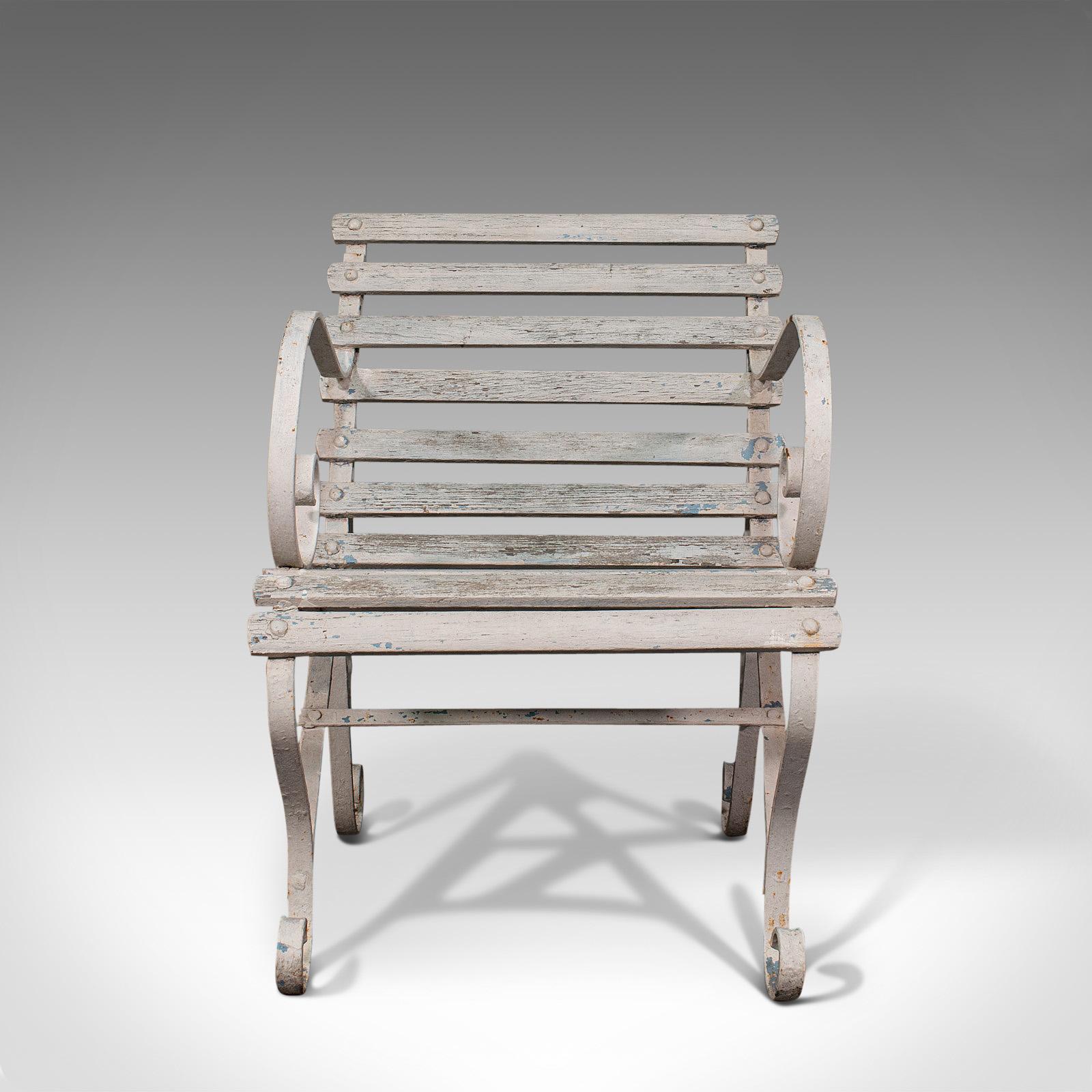 This is an antique garden seat. An English, wrought iron and wooden slatted outdoor chair, dating to the Victorian period, circa 1900.

Ornately scrolled forms a highlight of this appealing outdoor chair
Displays a desirable aged patina with