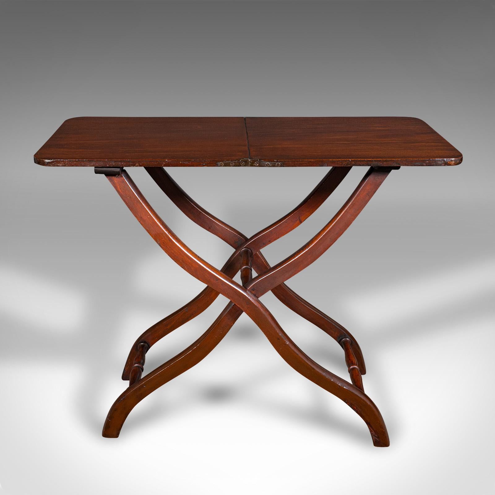 This is an antique garden tending table. An English, mahogany folding hobby or occasional table, dating to the Victorian period, circa 1880.

Charming serving table for occasional garden use or guest refreshments
Displaying a desirable aged patina