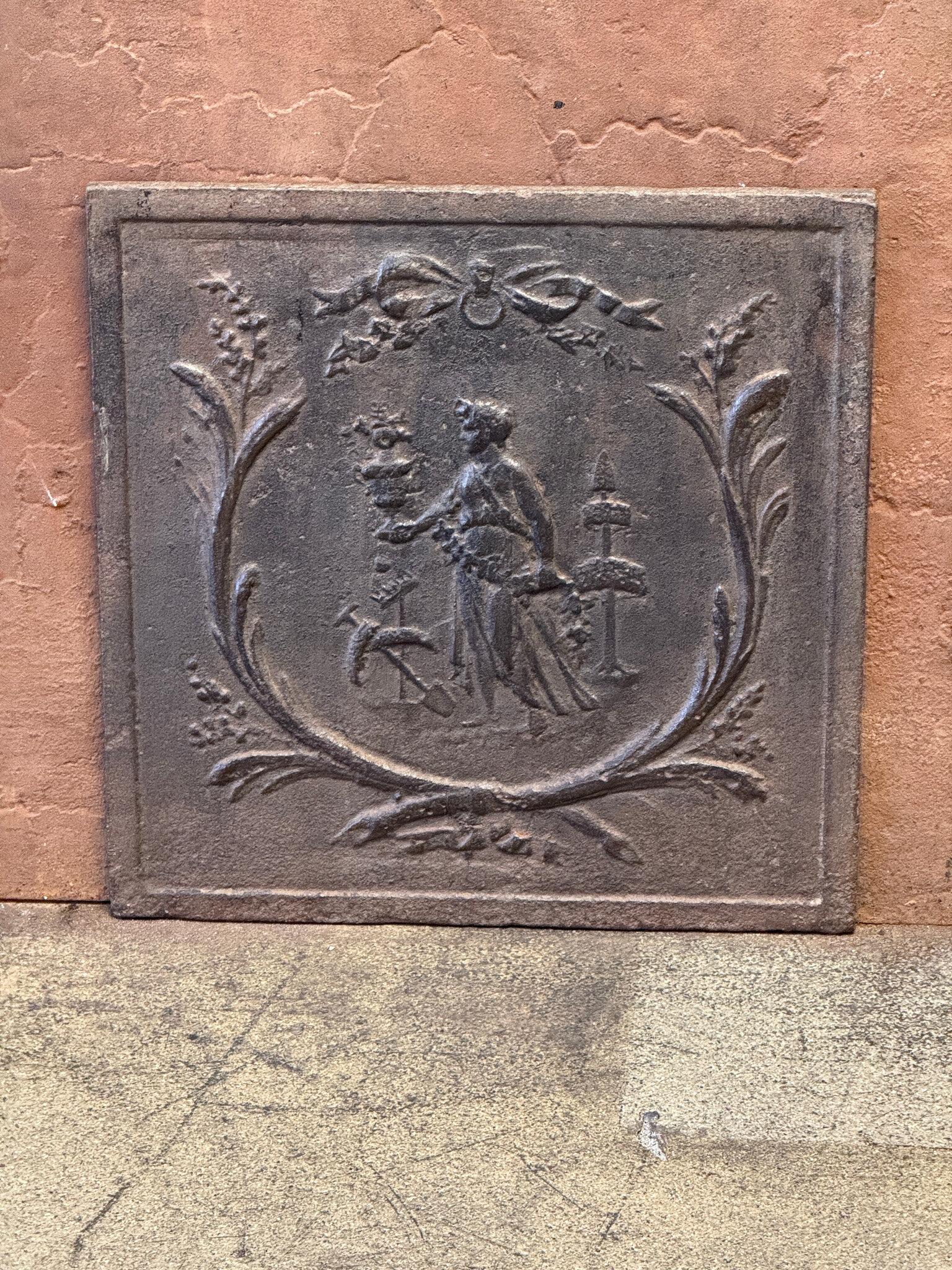 Early 19th century French 'Gardening' Fireback / Backsplash. 

The fireback is made of cast iron and has a natural brown patina. Upon request, it can be made black/pewter colored with stove polish at no extra cost. It is in good condition and does