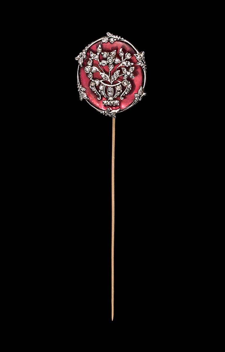 This wonderful stickpin is decorated with a diamond jardiniere. The diamonds are mounted in silver. The back of the pin has a beautifully pierced gold ornament.  