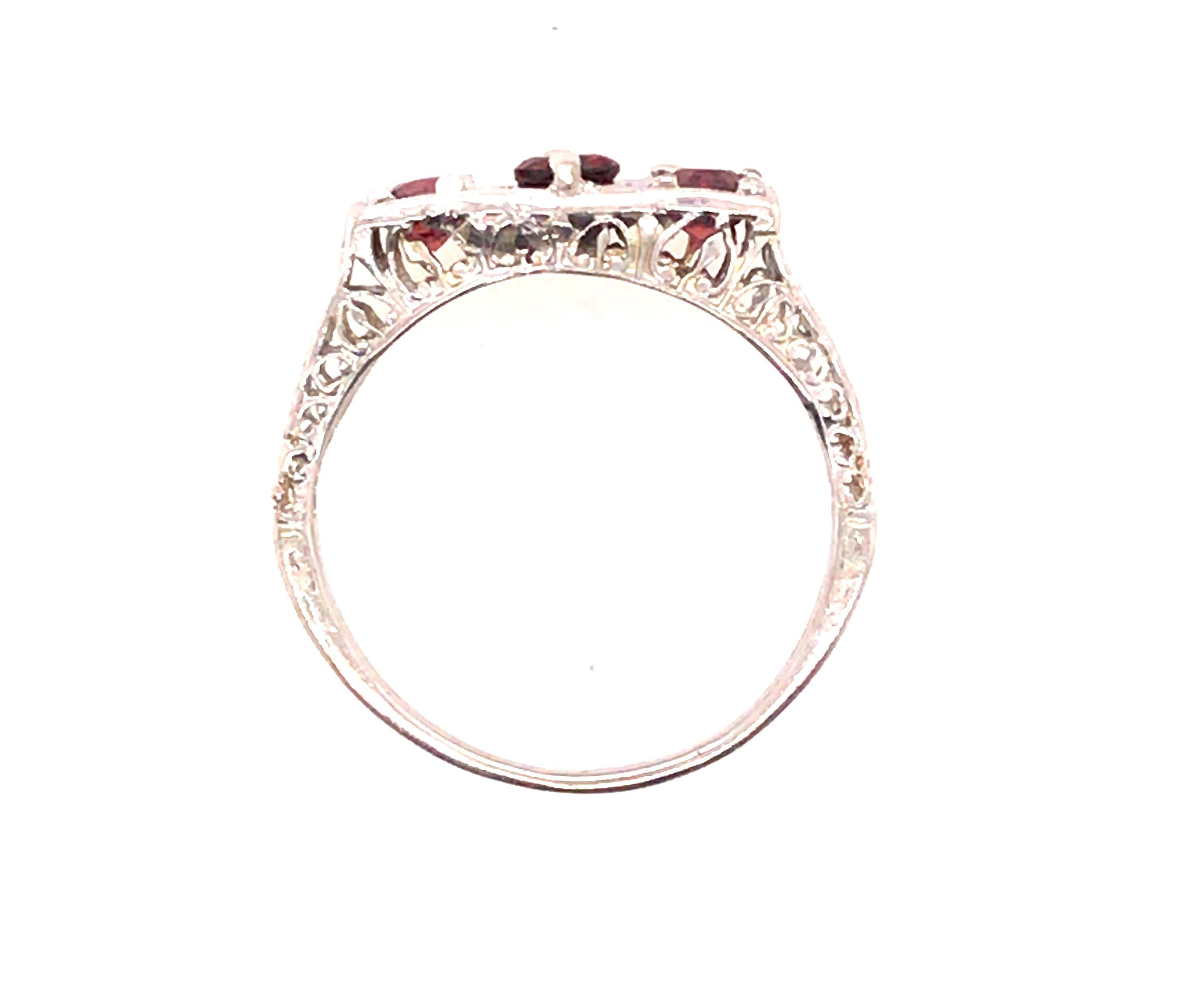 Genuine Original Art Deco Antique from 1920's-1930's Garnet 3 Stone Ring  .75ct Filigree 14K White Gold 


Features 3 Genuine Natural Round Garnet Gemstones

Solid Shank

Hand Carved Filigree

100% Natural Garnet Gemstones

.75 Carat Gemstone