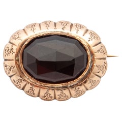 Broche antiguo de granate y oro de 14 quilates