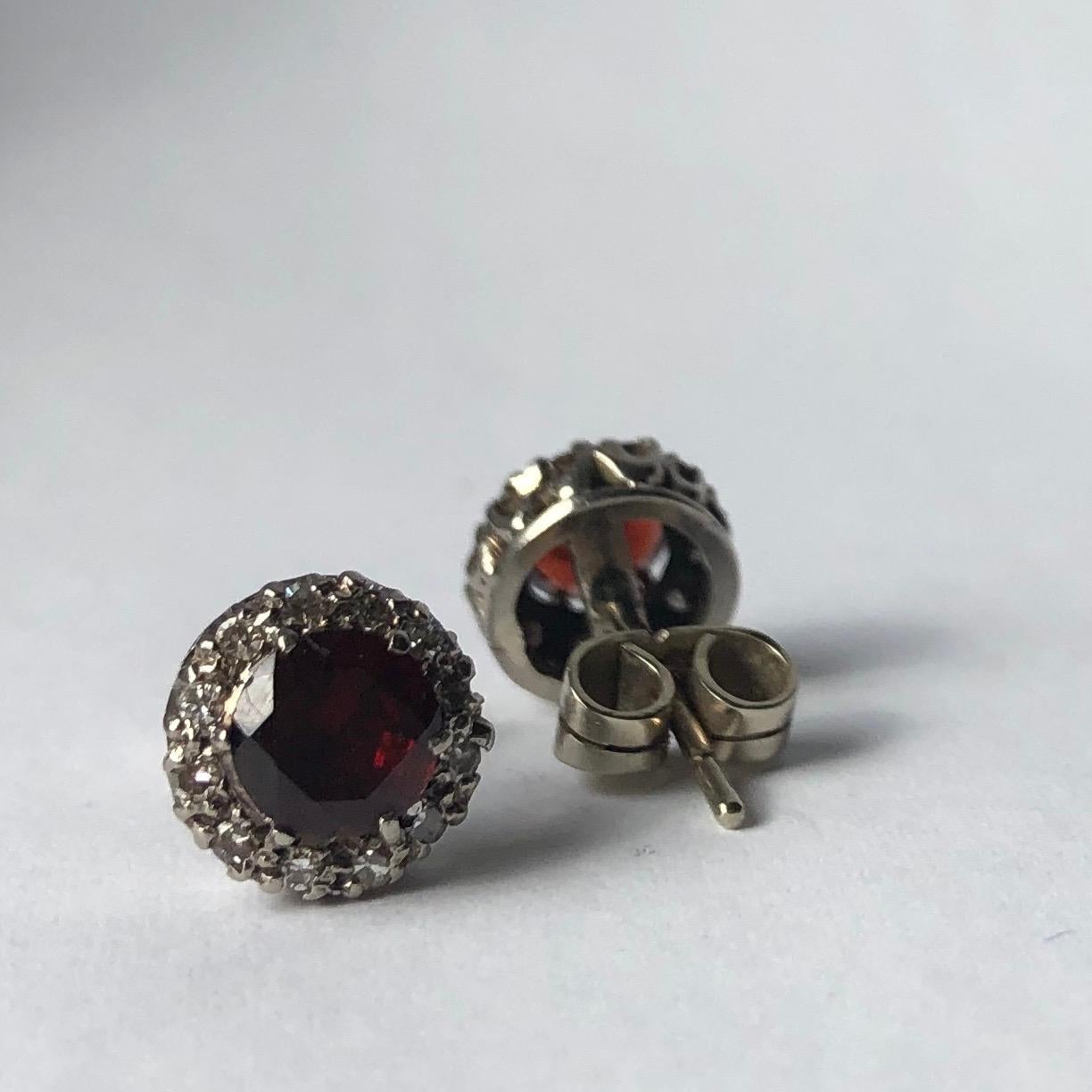 The 75pt garnets at the centre of these clusters are a beautiful deep, rich red colour and are surrounded by a halo of glistening diamonds. The diamonds total approximately 10pts per earring.

Cluster Diameter: 8.5mm 

Weight: 2.8g
