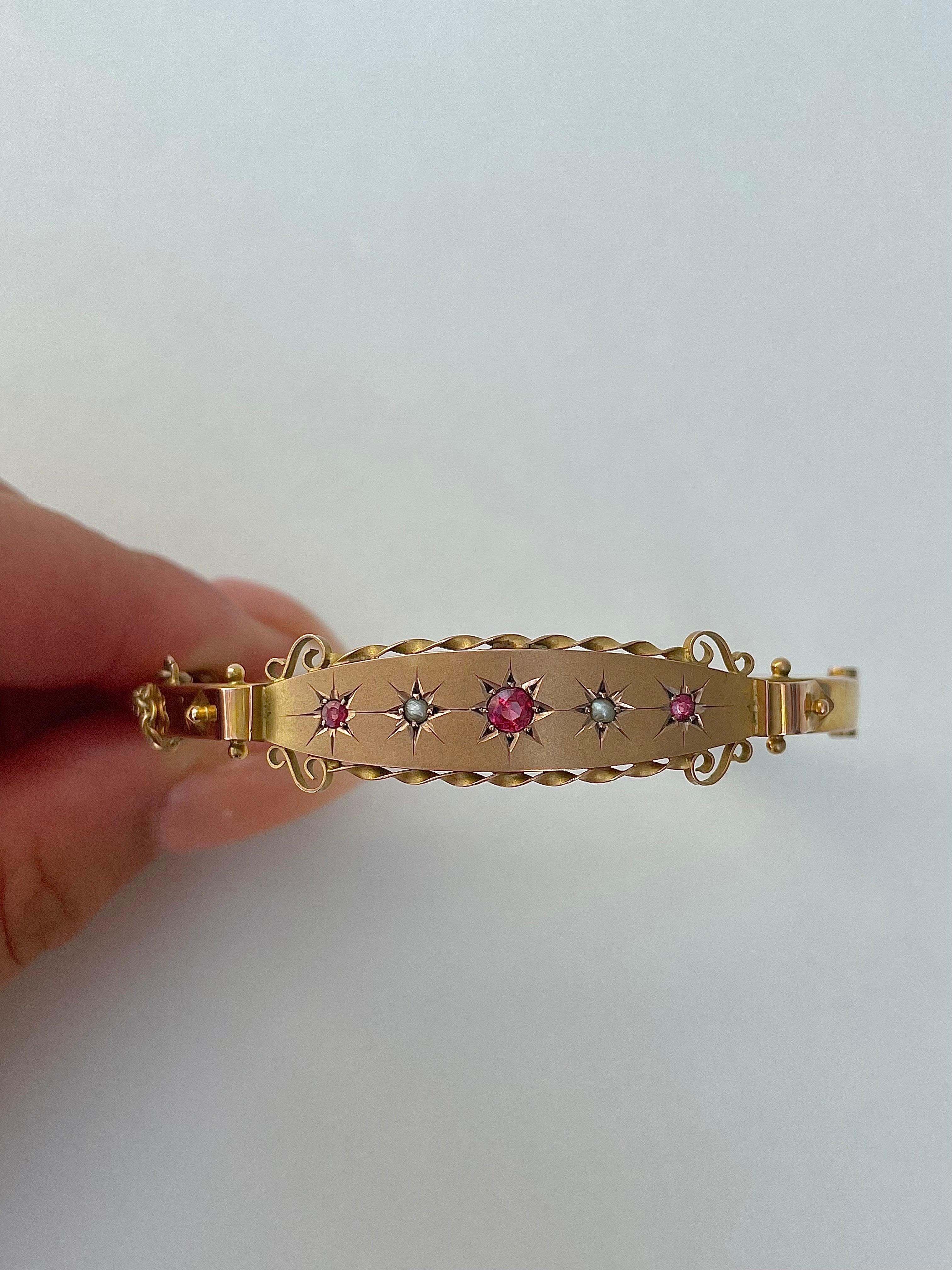 Antique Garnet and Pearl Star Bangle 9ct Gold 

the most beautiful garnet and pearl star row with a twist detail on either side, truly exquisite 

The item comes without the box in the photos but will be presented in a gift box

Measurements: weight