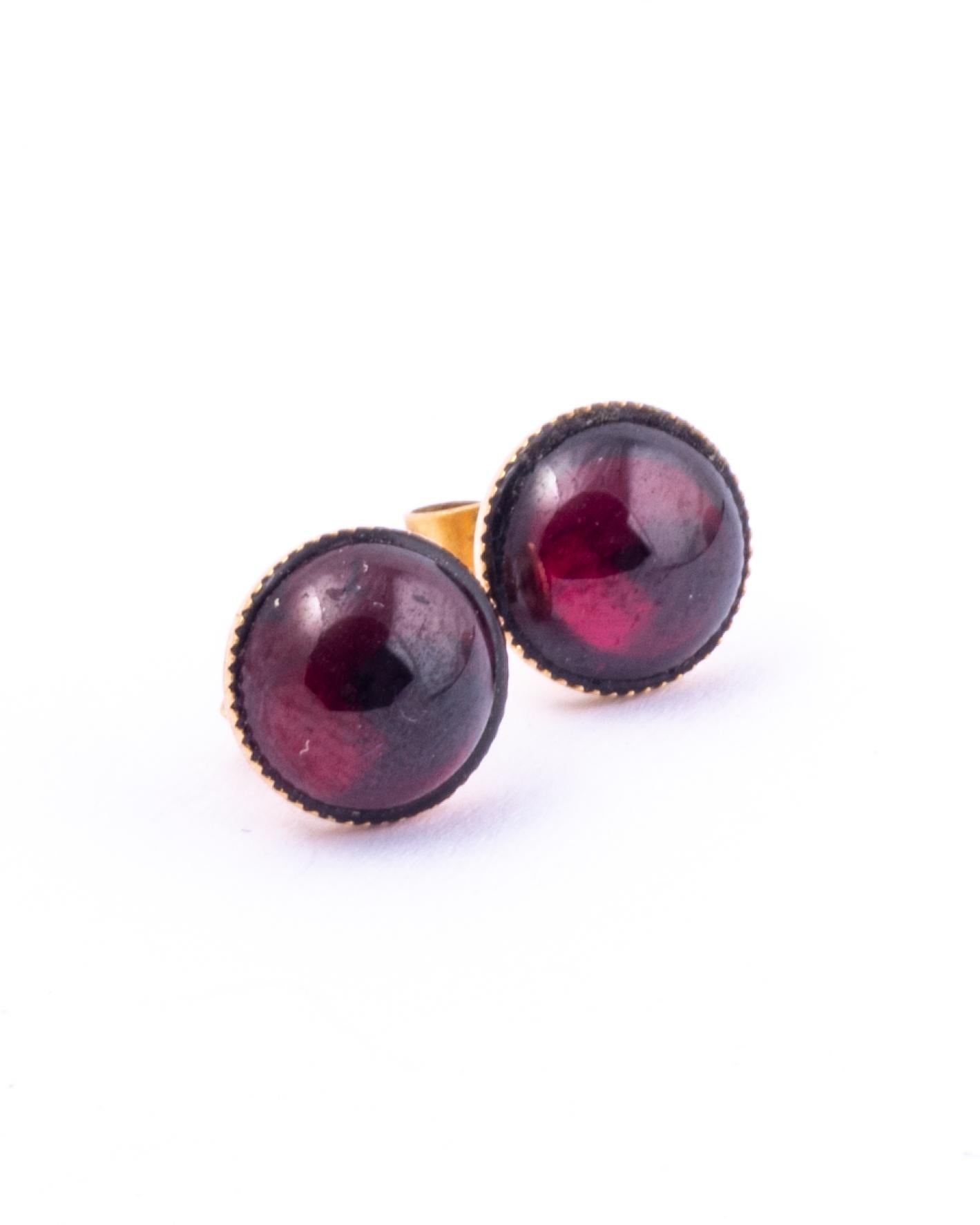 These gorgeous earrings hold smooth and glossy garnet stones set in 9carat gold. 

Stone Diameter: 8mm

Weight: 1.5g