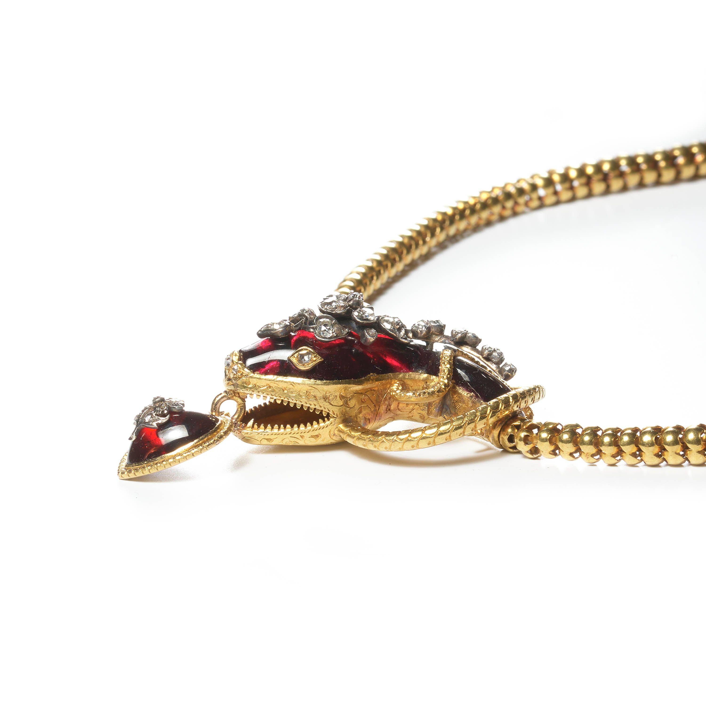 A Victorian garnet and diamond snake necklace, with old-cut and rose-cut diamonds, in a floral design, in silver settings, on a cabochon-cut garnet, forming the head, with a diamond set heart shaped garnet pendant, hanging from the open mouth, with