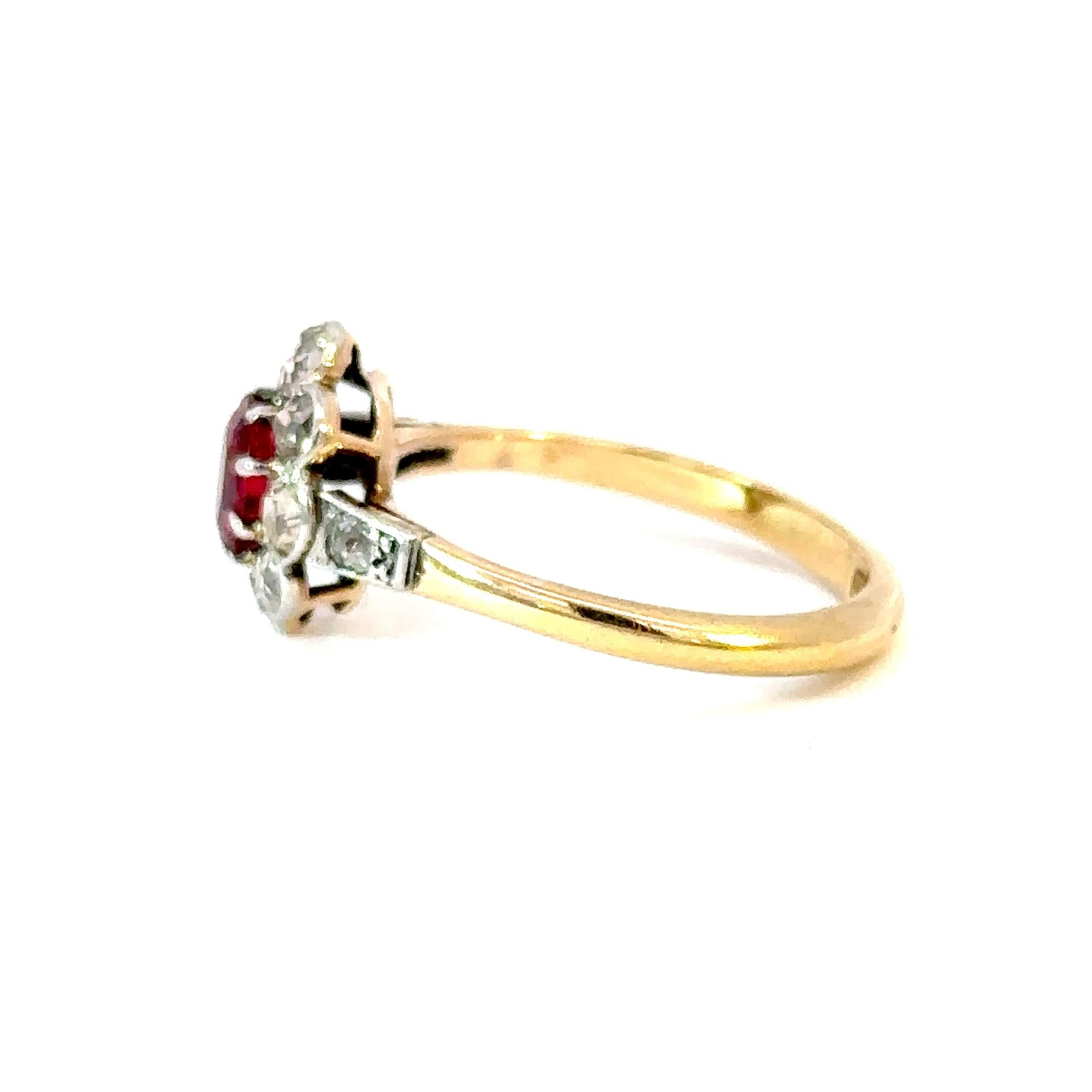Step into a world of refined antique charm with this exquisite Edwardian-era cluster ring, a true testament to timeless design and craftsmanship. Handcrafted in platinum over 18kt yellow gold, the ring features a graceful scalloped silhouette