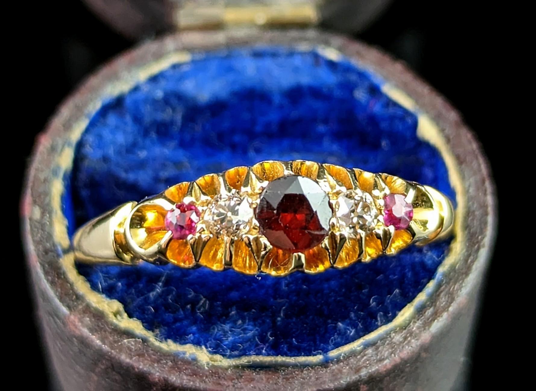 This beautiful antique, Edwardian era Ruby, Garnet and Diamond ring is an unusual stone combination in tones that complement each other wonderfully.

It is a boat head style of ring in rich, buttery 18kt yellow gold with gemstone set face.

It is