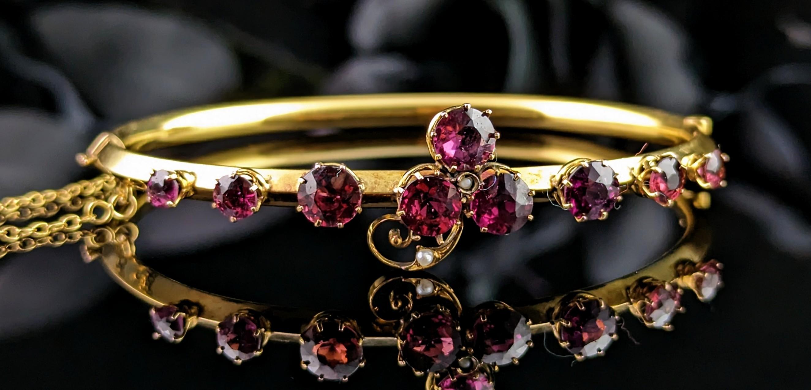 This stunning antique Shamrock bangle is a real beauty!

The combination of the rich purple toned Almandine garnets with the rich bloomed 9kt yellow gold gives the piece an instant luxurious feel.

It is crafted in the richest 9kt yellow gold with a
