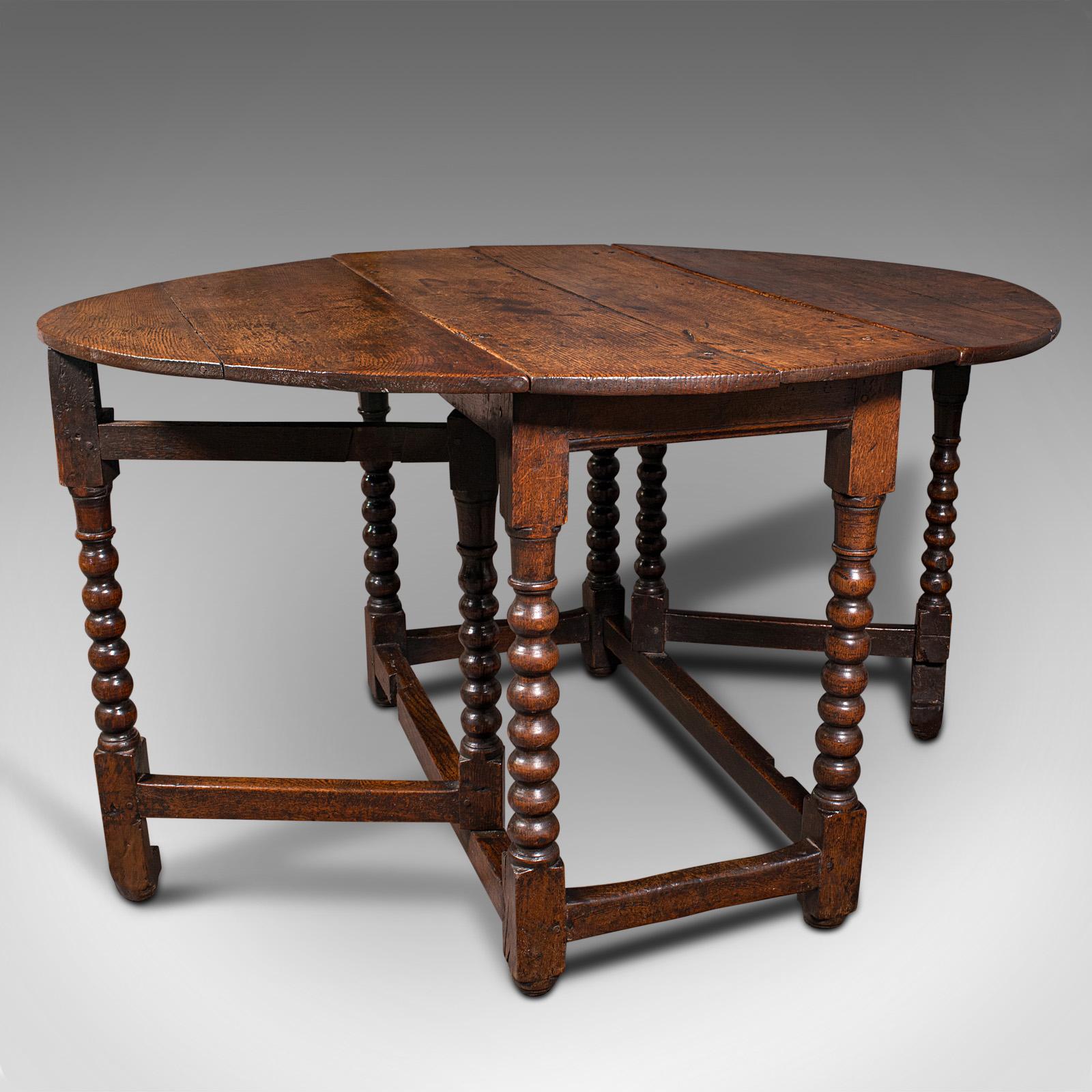 This is an antique gate leg table. An English, oak oval extending provincial table, dating to the William III period, circa 1700.

Delightfully presented table, as useful today as it was over 300 years ago
Displaying a desirable aged patina and in