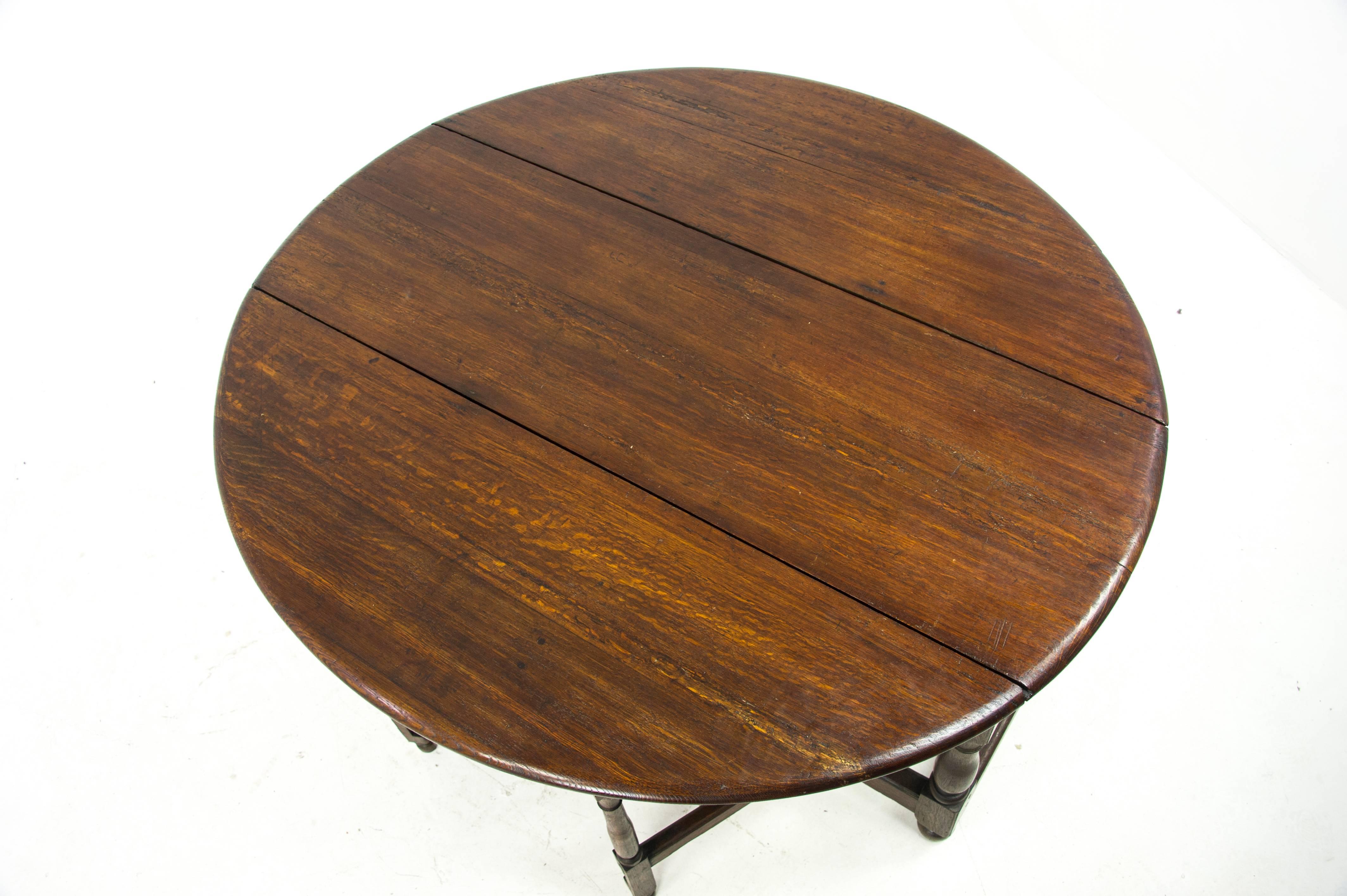 Antique gateleg table, oak drop-leaf table, George third table, Scotland, 1800, Antique Furniture, B1031.

Scotland, 1800
Solid oak construction
Original finish
Features an oval drop-leaf top with two gatelegs underneath
Thick wooden top and