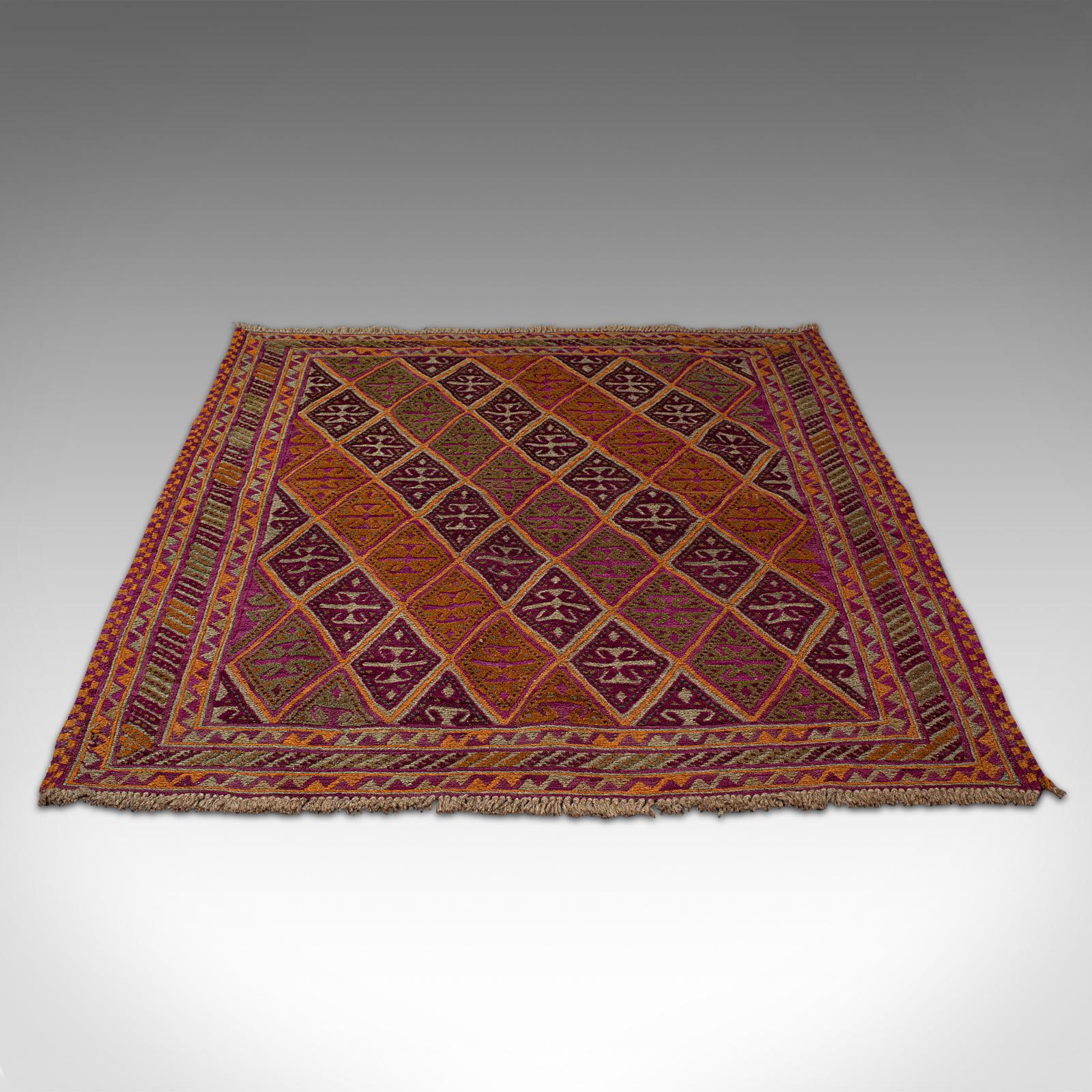 This is an antique Gazak rug. A Middle Eastern, nomadic tribal woven decorative carpet, dating to the late 19th century, circa 1900.

Great colour and of near-square size at 119cm x 131cm (46.75