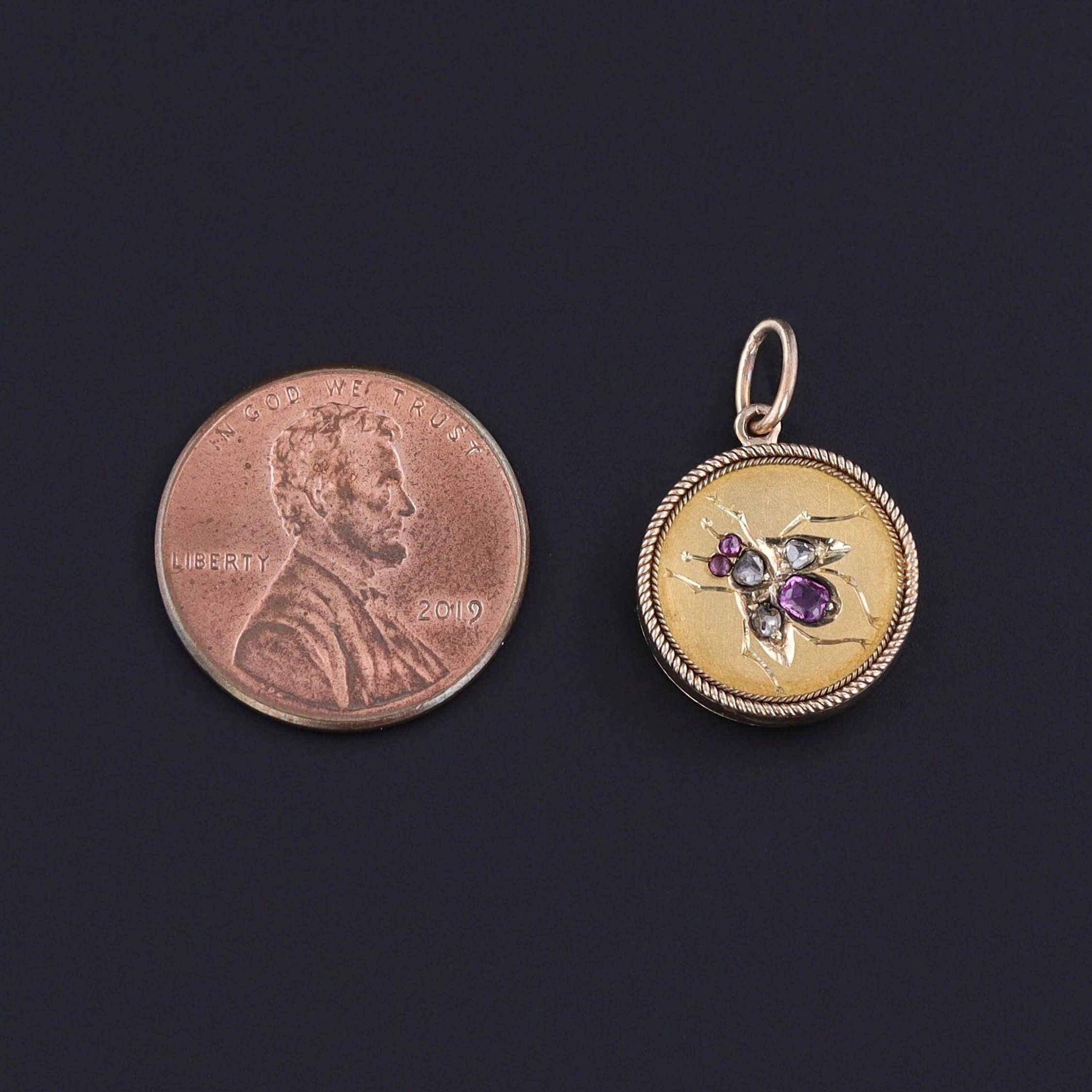 This whimsical charm features an insect of rubies and diamonds mounted in 14k gold. The charm was originally an antique stickpin (circa 1890-1910) that our jeweler transformed by removing the pin and adding a 14k gold jump ring.

The piece measures