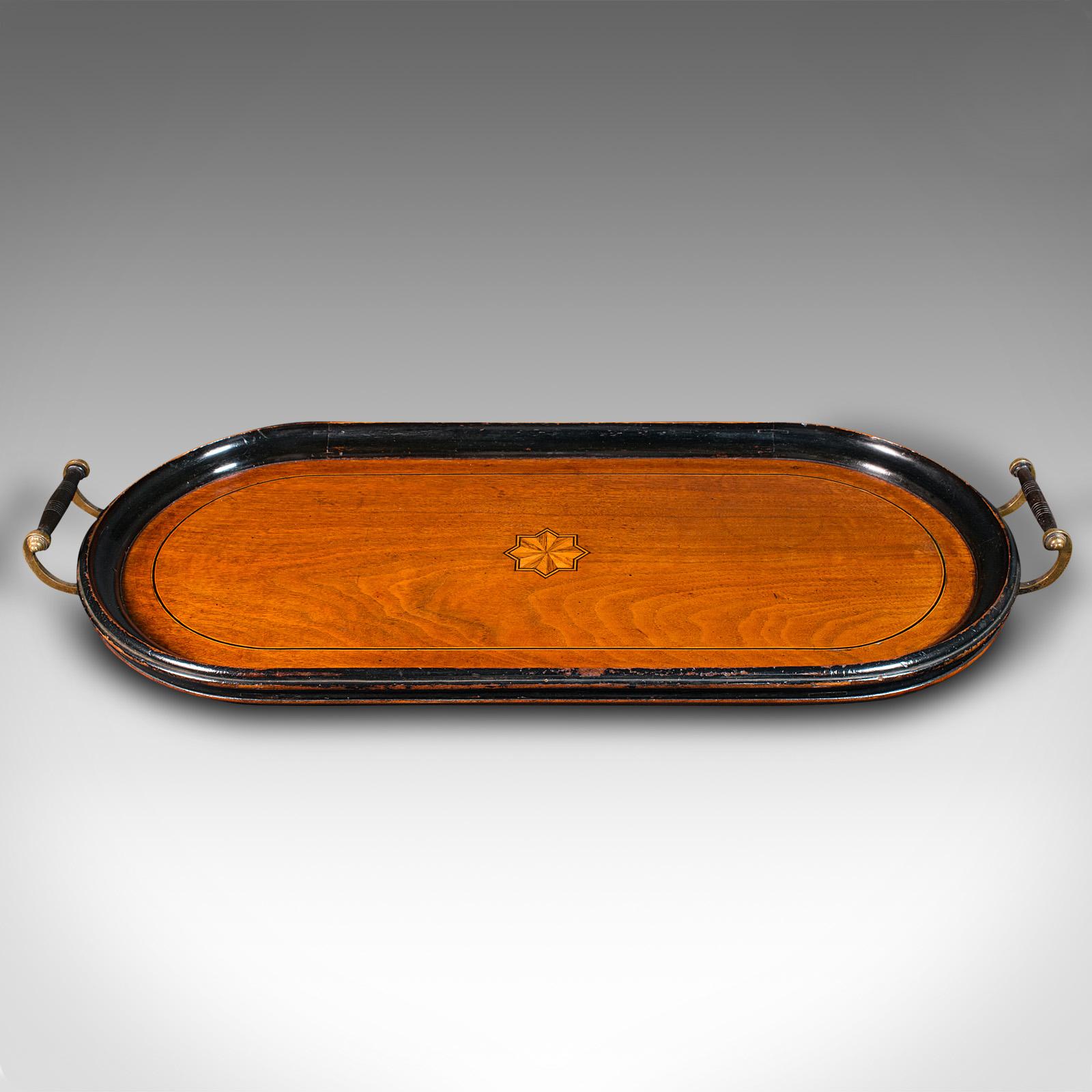 This is an antique gentleman's club serving tray. An English, ebonised walnut and boxwood inlaid afternoon tea tray, dating to the late Victorian period, circa 1880.

Fascinating elongated oval form, ideal for decanters and glasses
Displays a