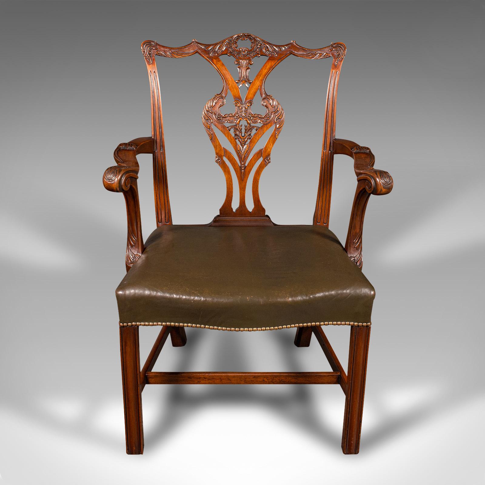 
This is an antique gentleman's drawing room armchair. An English, mahogany elbow chair in Chippendale taste, dating to the late Victorian period, circa 1900.

Presents wonderful Chippendale taste with an eye-catching back rest
Displays a desirable